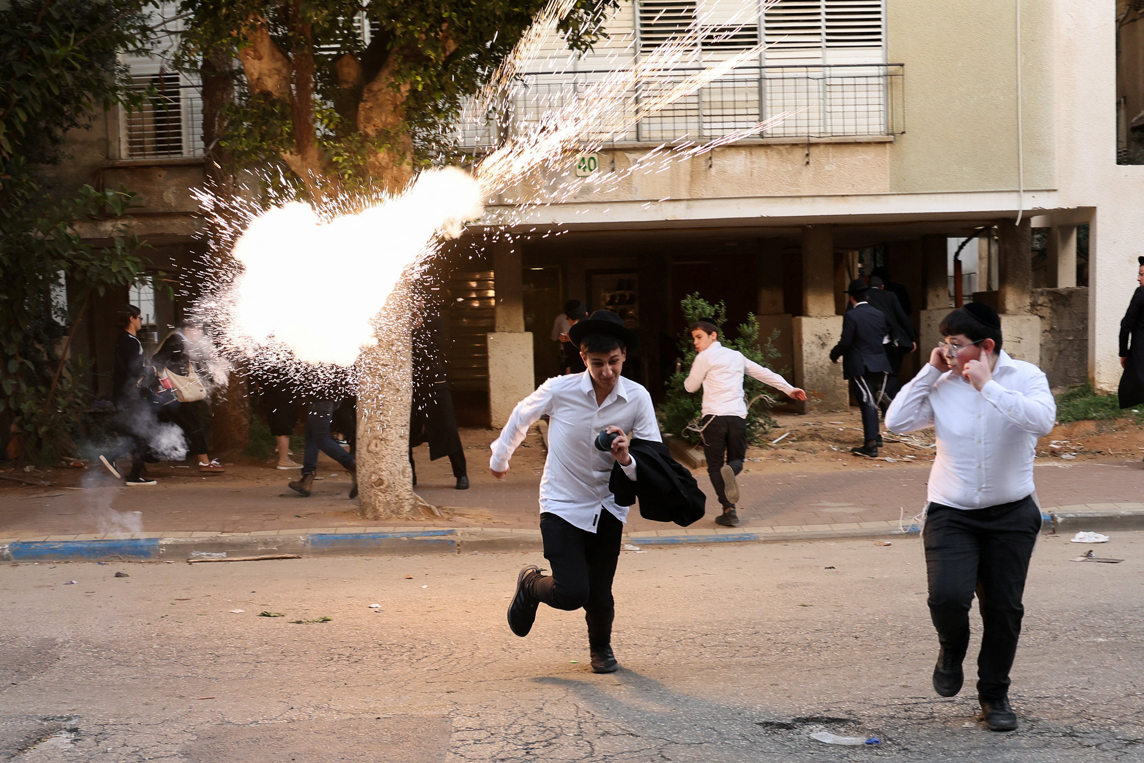 Police are searching for rioters who overturned a patrol car