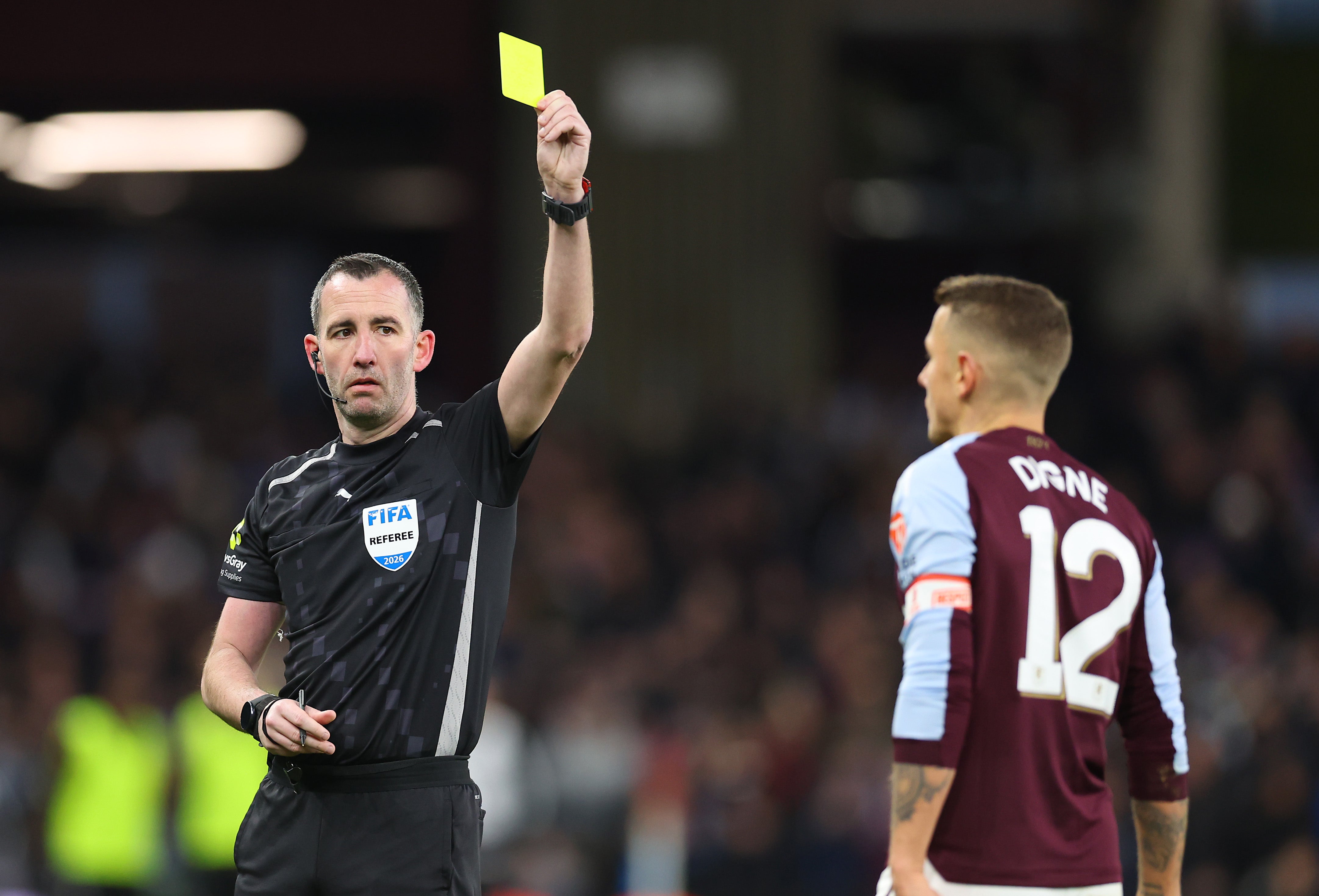 Lucas Digne of Aston Villa is shown a yellow card by referee Chris Kavanagh during the Emirates FA Cup Fourth Round match between Aston Villa and Newcastle United
