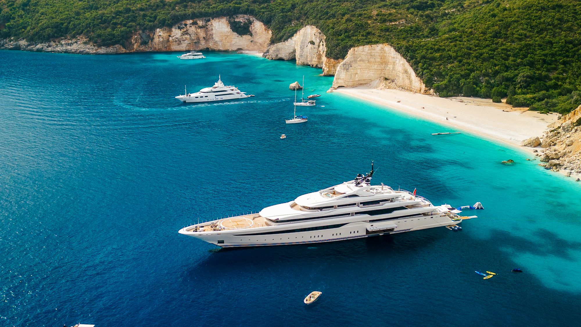 A superyacht in the beautiful bay of Fteri beach on Kefalonia, Greece: ‘I have stood in tropical gardens with hummingbirds and on yachts with dolphins leaping alongside, and my employers barely noticed’