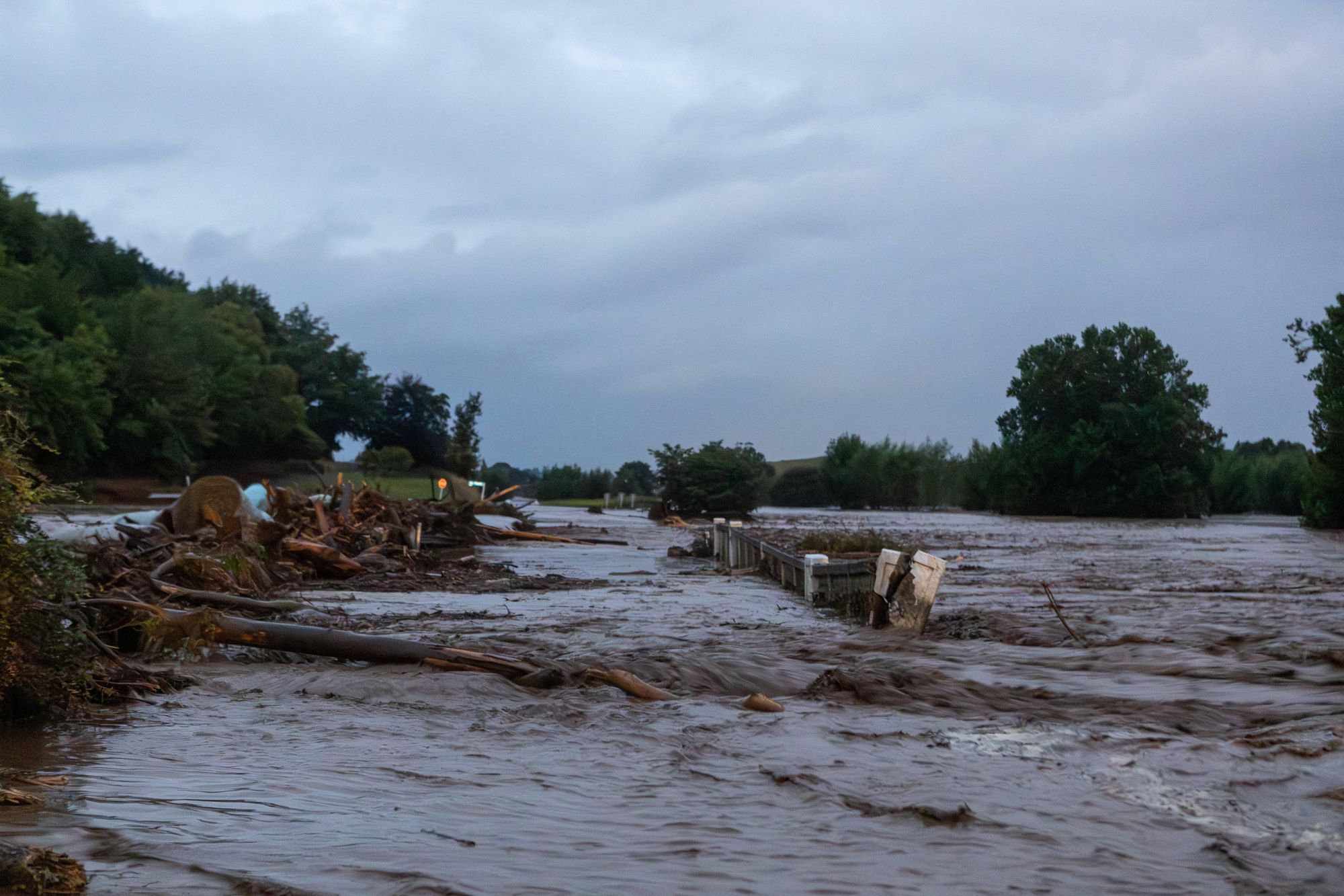 Floodwaters cover the road after heavy rain and wild winds in Puketotara, Waikato region, New Zealand, 13 February 2026, in this picture obtained from social media