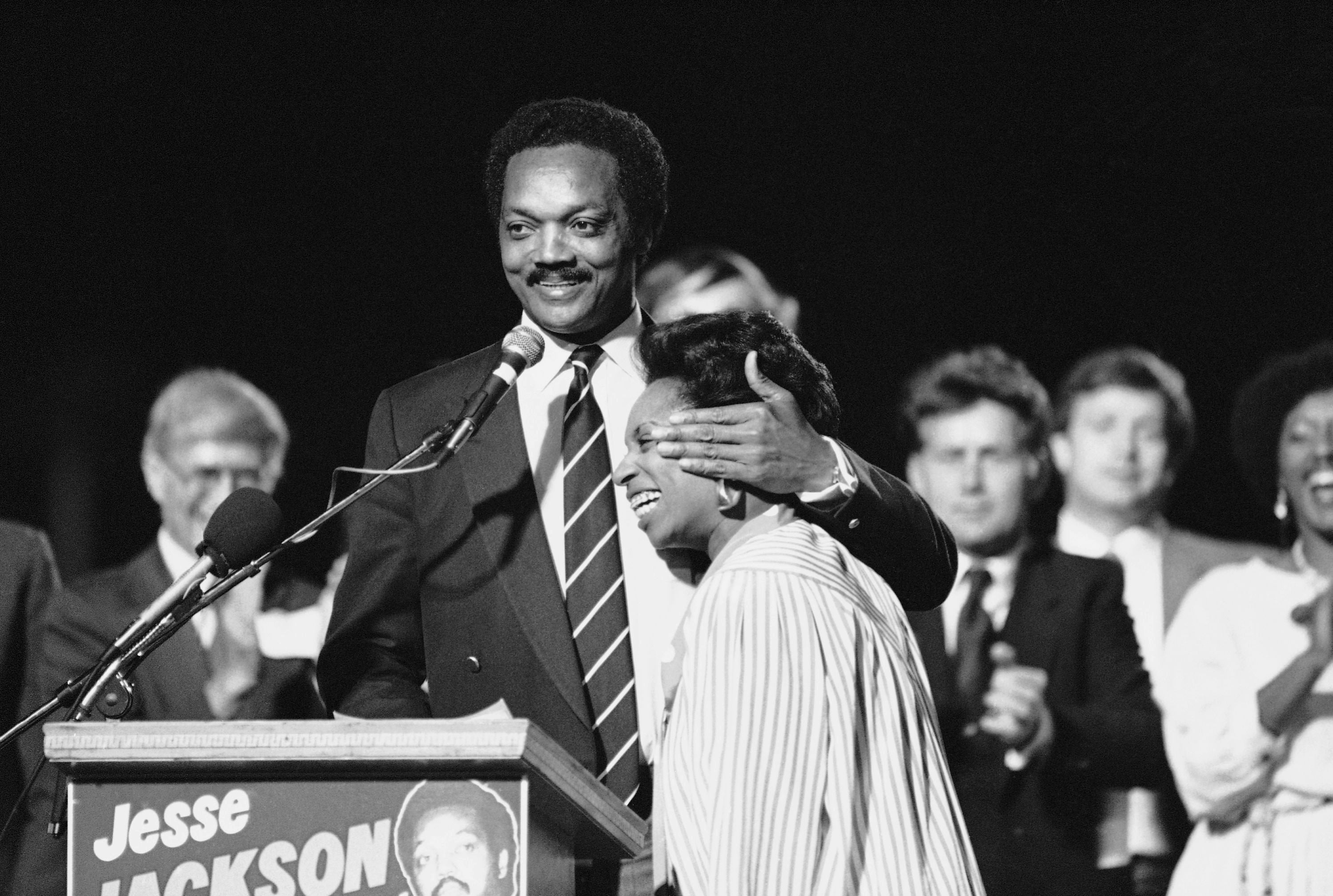 Jackson, then a Democratic presidential candidate, gives his wife Jacqueline a warm embrace on stage in Los Angeles in May 1984