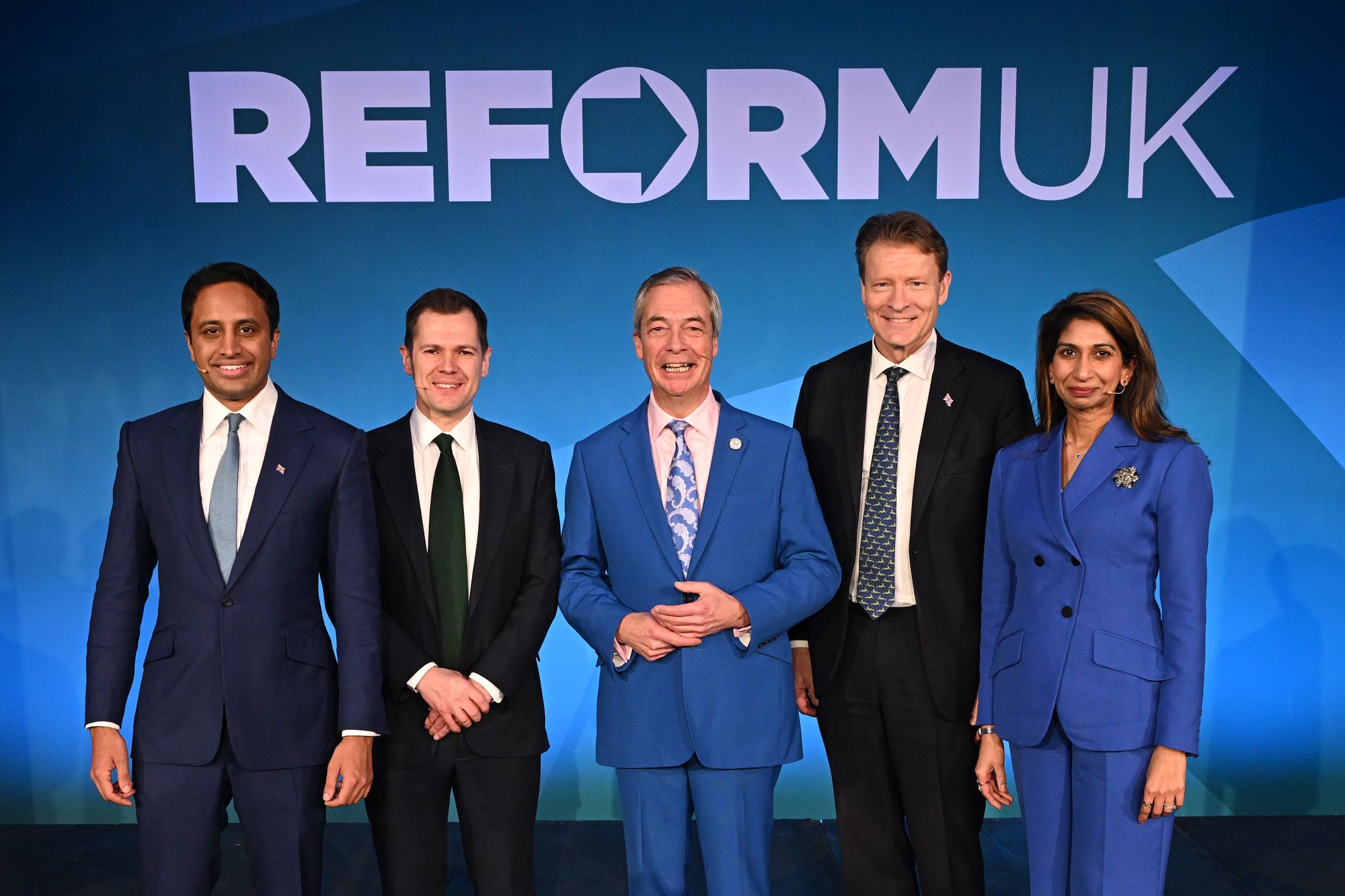 Reform UK Leader Nigel Farage stands with Zia Yusuf, Shadow, Robert Jenrick, Shadow, Richard Tice and Suella Braverman