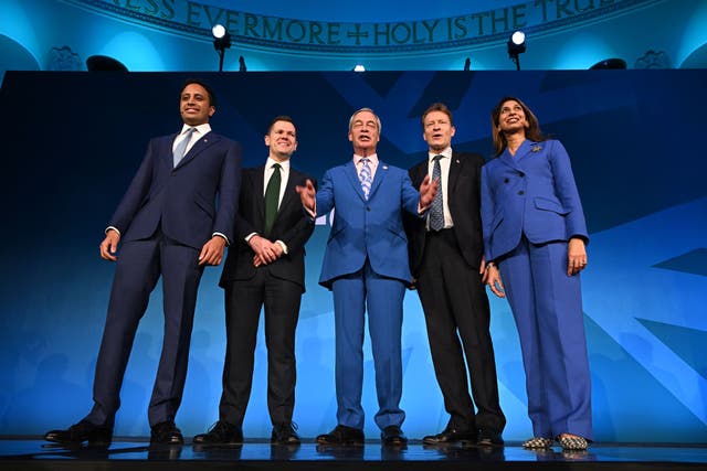 <p>Nigel Farage stands with his newly unveiled top team </p>