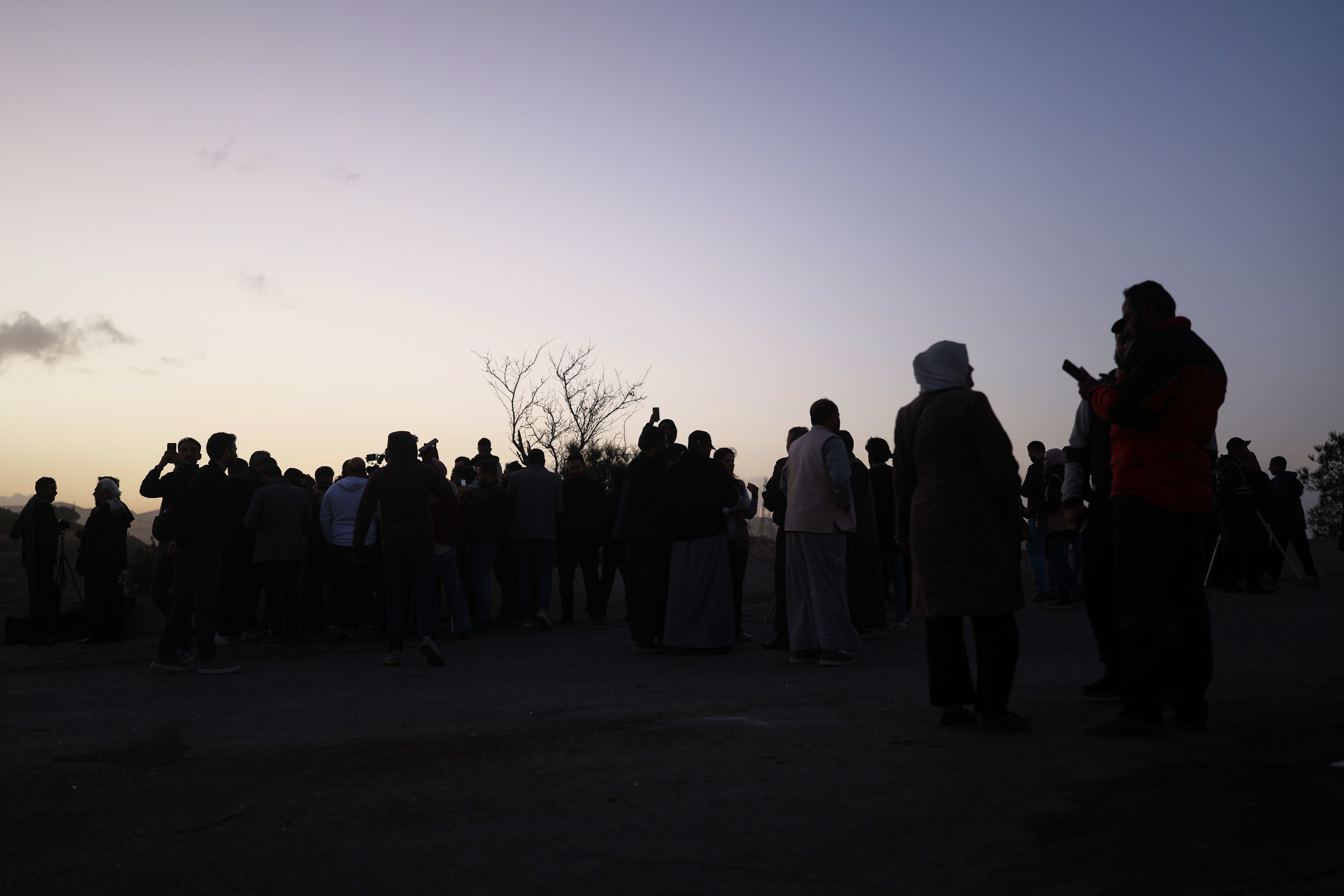 People gather to sight the Ramadan crescent moon marking the beginning of the holy month of Ramadan at the foothills of Mount Qasioun near the Tomb of the Unknown Soldier in Damascus