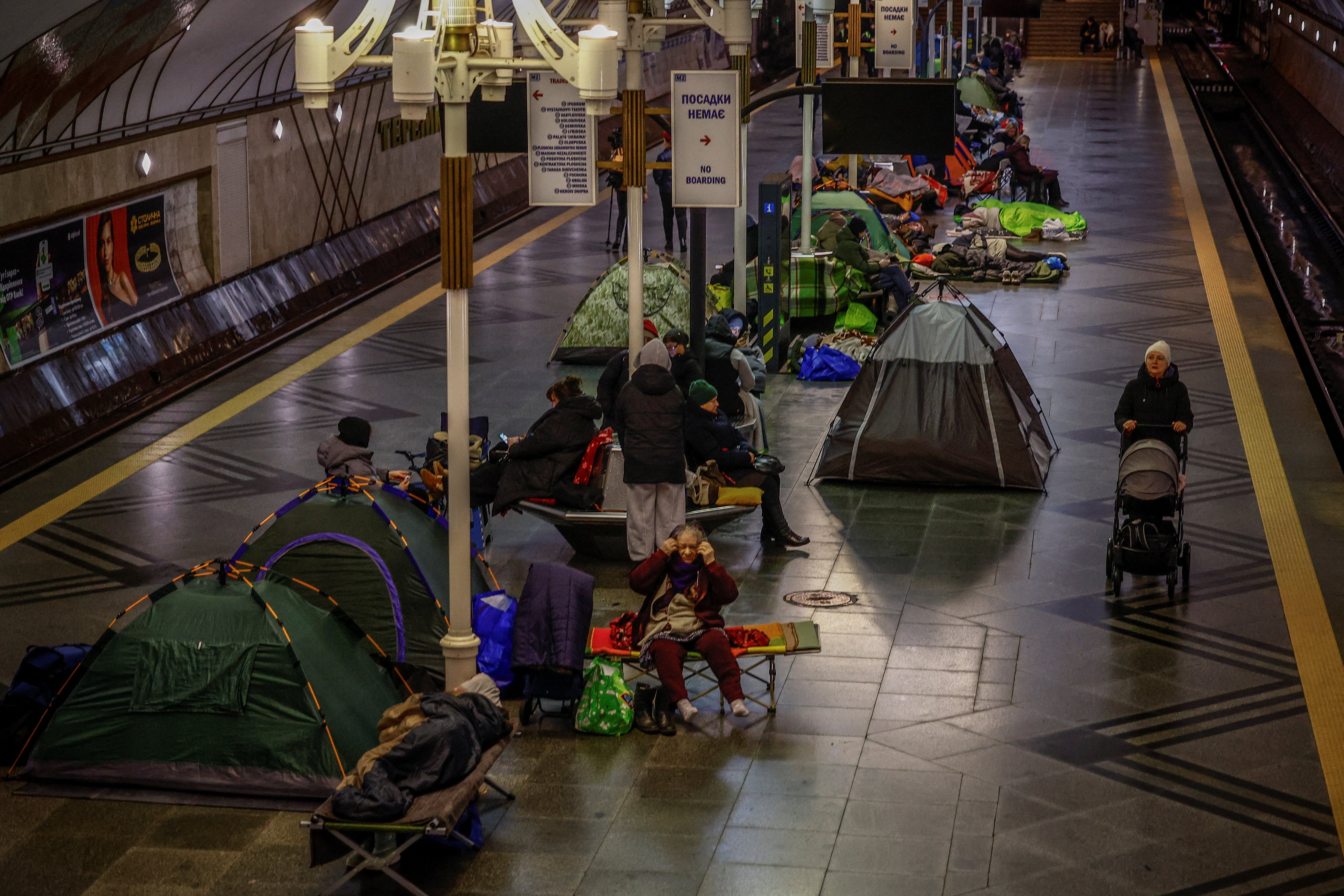 Several residents move inside a metro station in Kyiv during an air raid alert after overnight Russian drone and missile strike continues across the country
