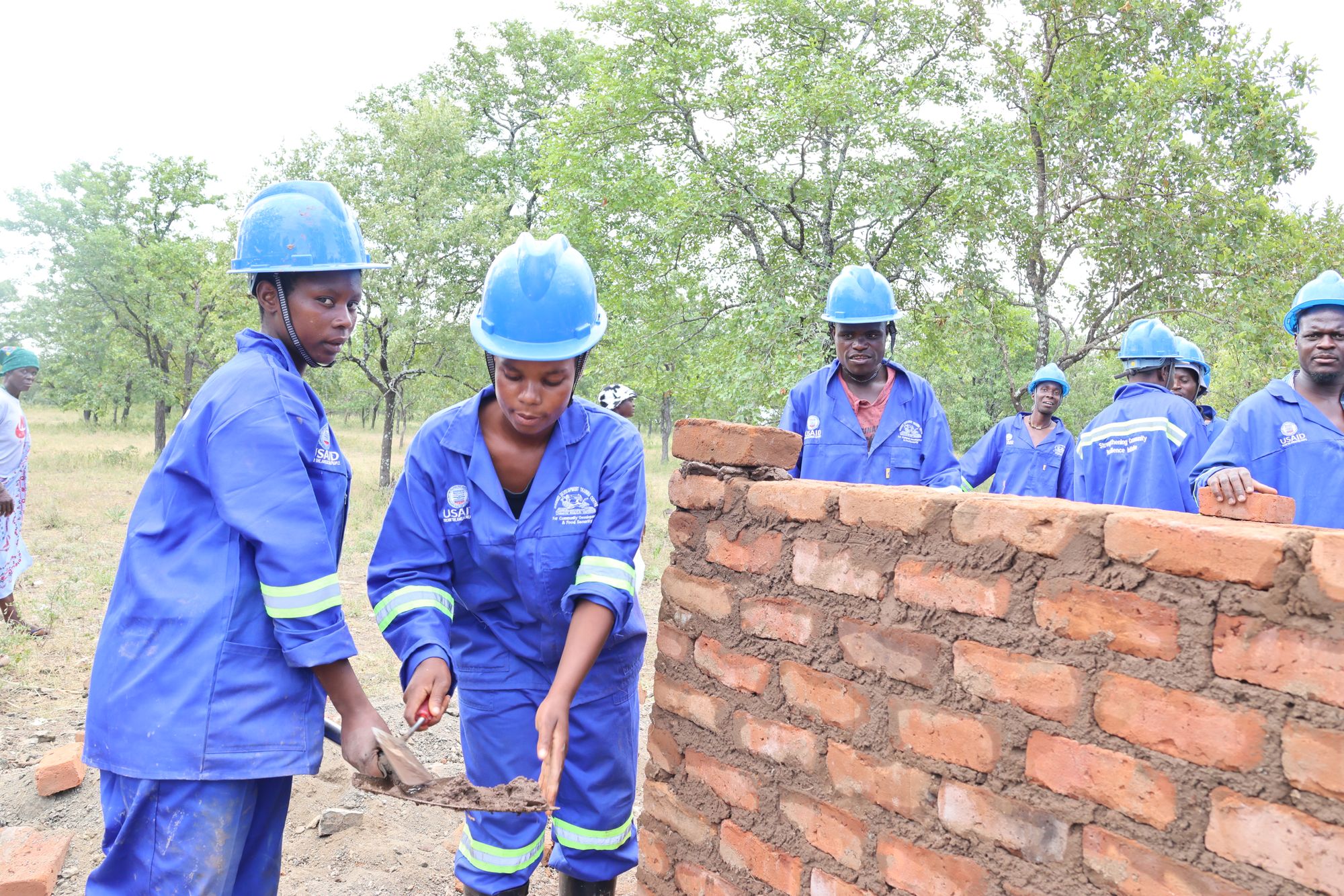 Silence Ncube and Meriyini Baloyi constructing pit latrine toilet at Ramadhaka community Borehole in Chiredzi. USAID supported vocational training for community members