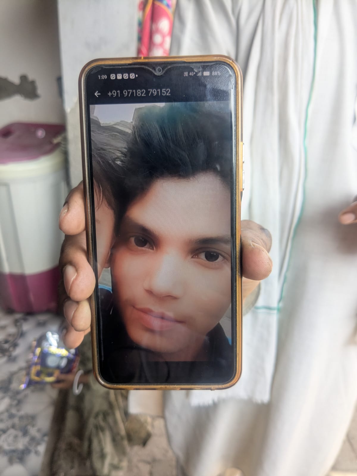 Mohammad Hakimuddin shows a picture of his deceased son