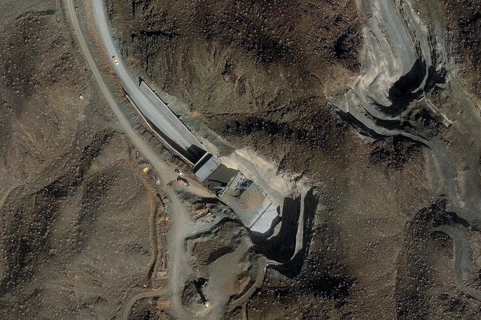 A satellite image shows ongoing efforts to harden and strengthen a facility's two tunnel entrances at a complex near Nantanz, Iran