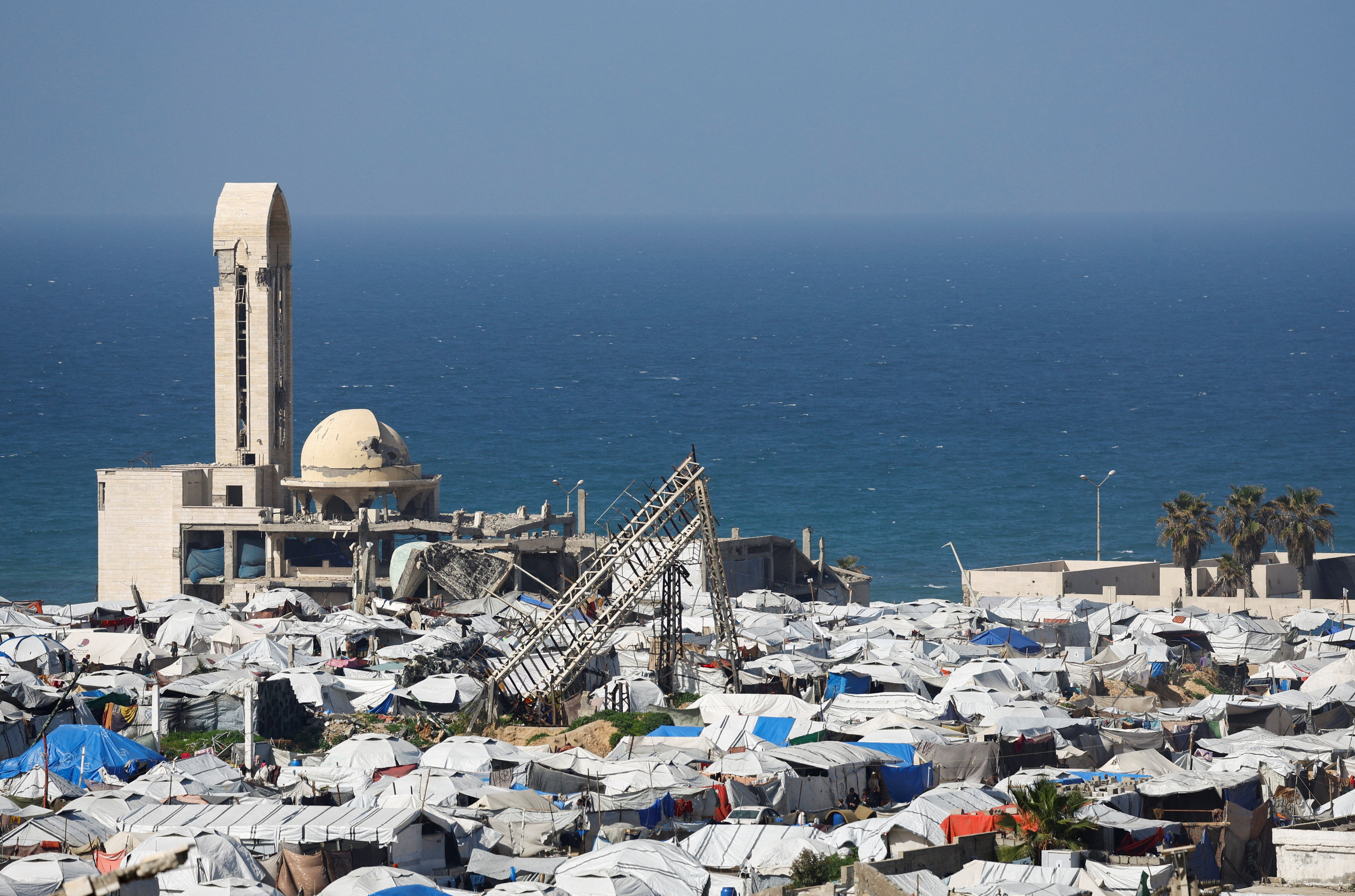 A mosque, destroyed during the two-year Israeli offensives, is surrounded by tents for displaced Palestinians, in Gaza City