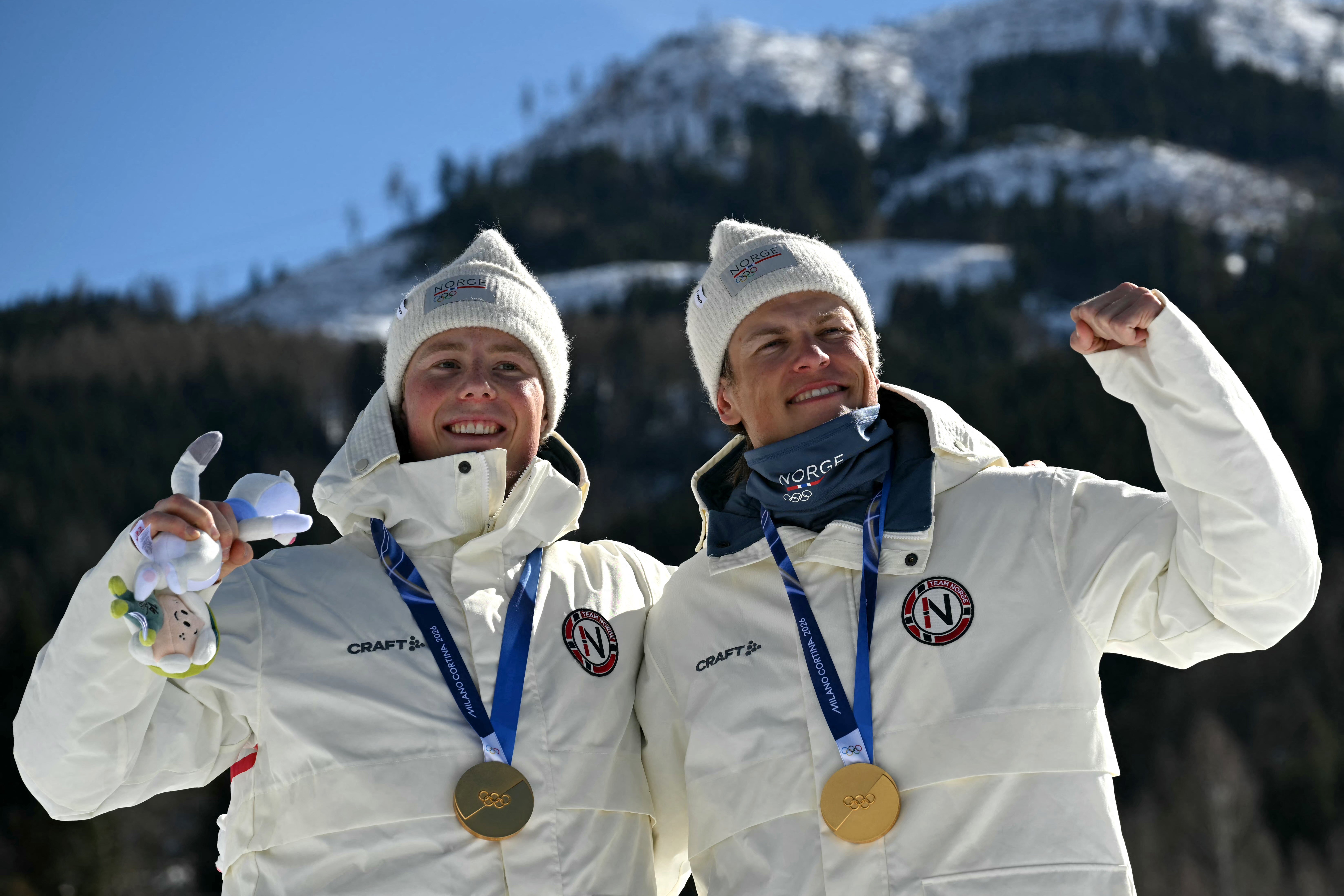 Einar Hedegart (left) with Norway teammate Johannes Hoesflot Klaebo after winning gold in the men's team cross country free sprint