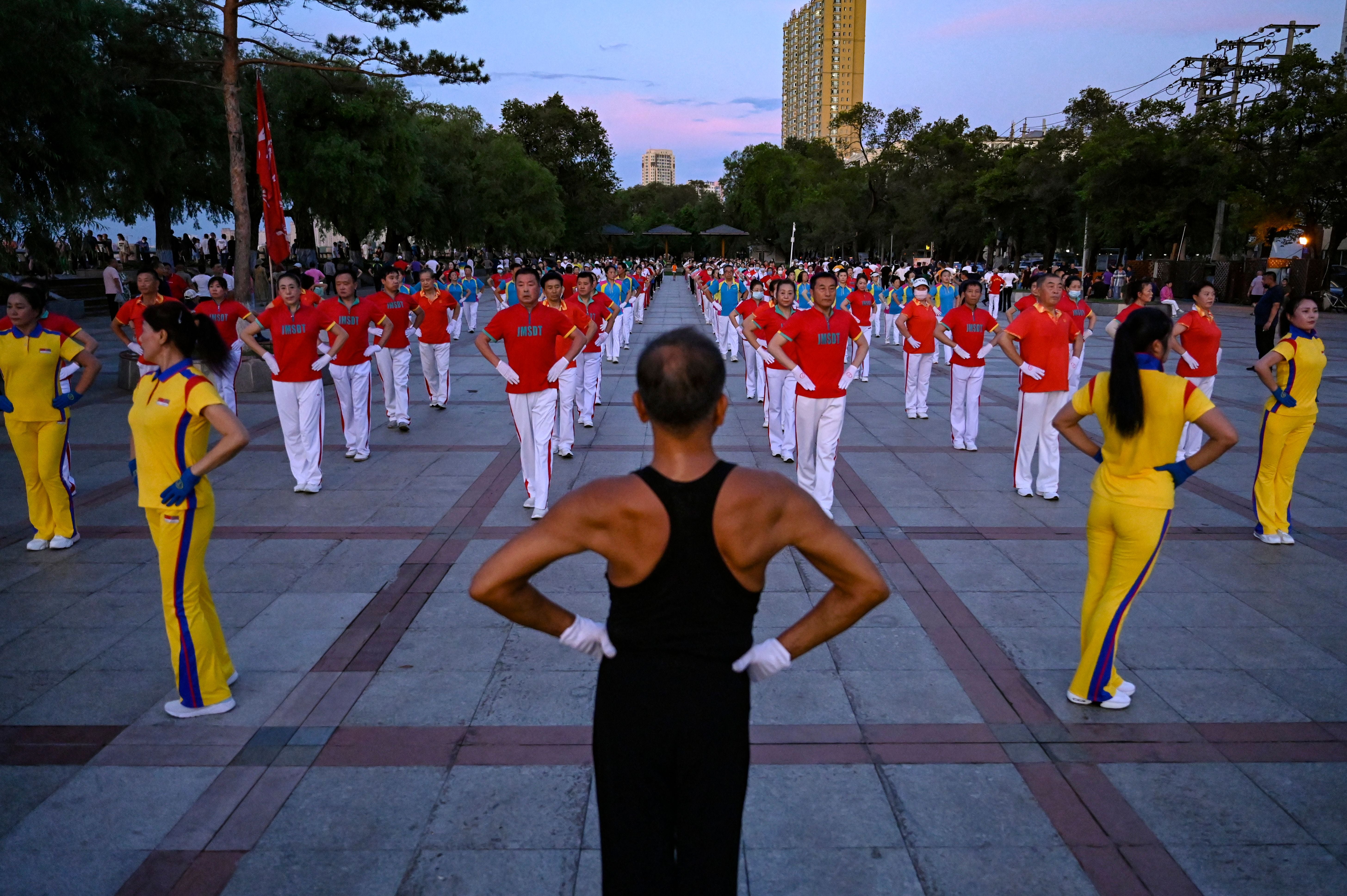 Local residents taking part in an aerobics exercise at a square in Jiamusi, in northeastern China's Heilongjiang