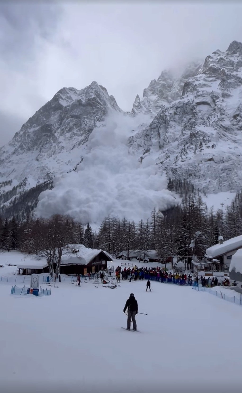 People began to flee as the avalanche loomed over the pine trees