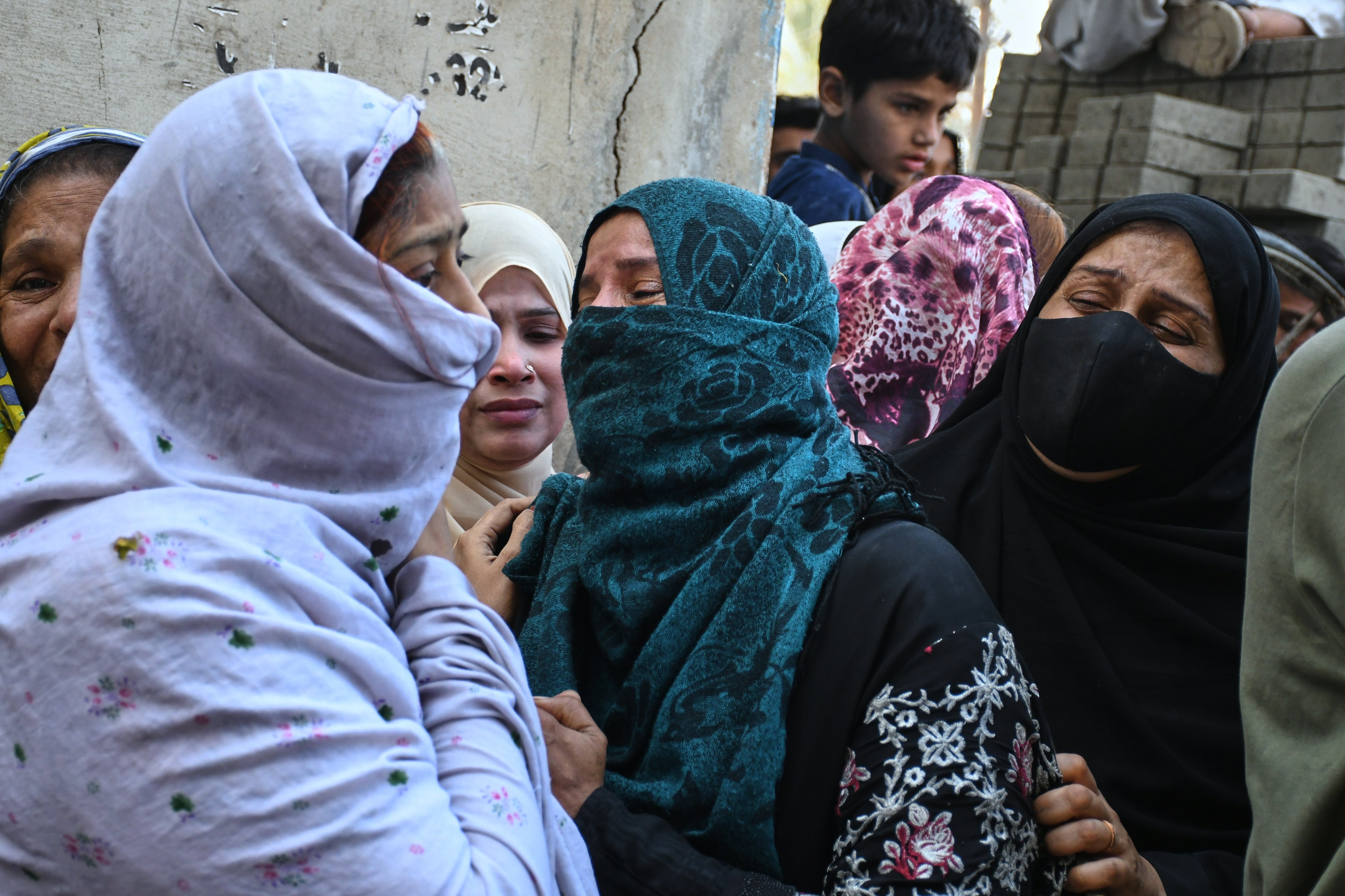 Women mourn over the death of their relatives near the site of a gas explosion in an apartment building, in Karachi, Pakistan, Thursday, 19 February 2026