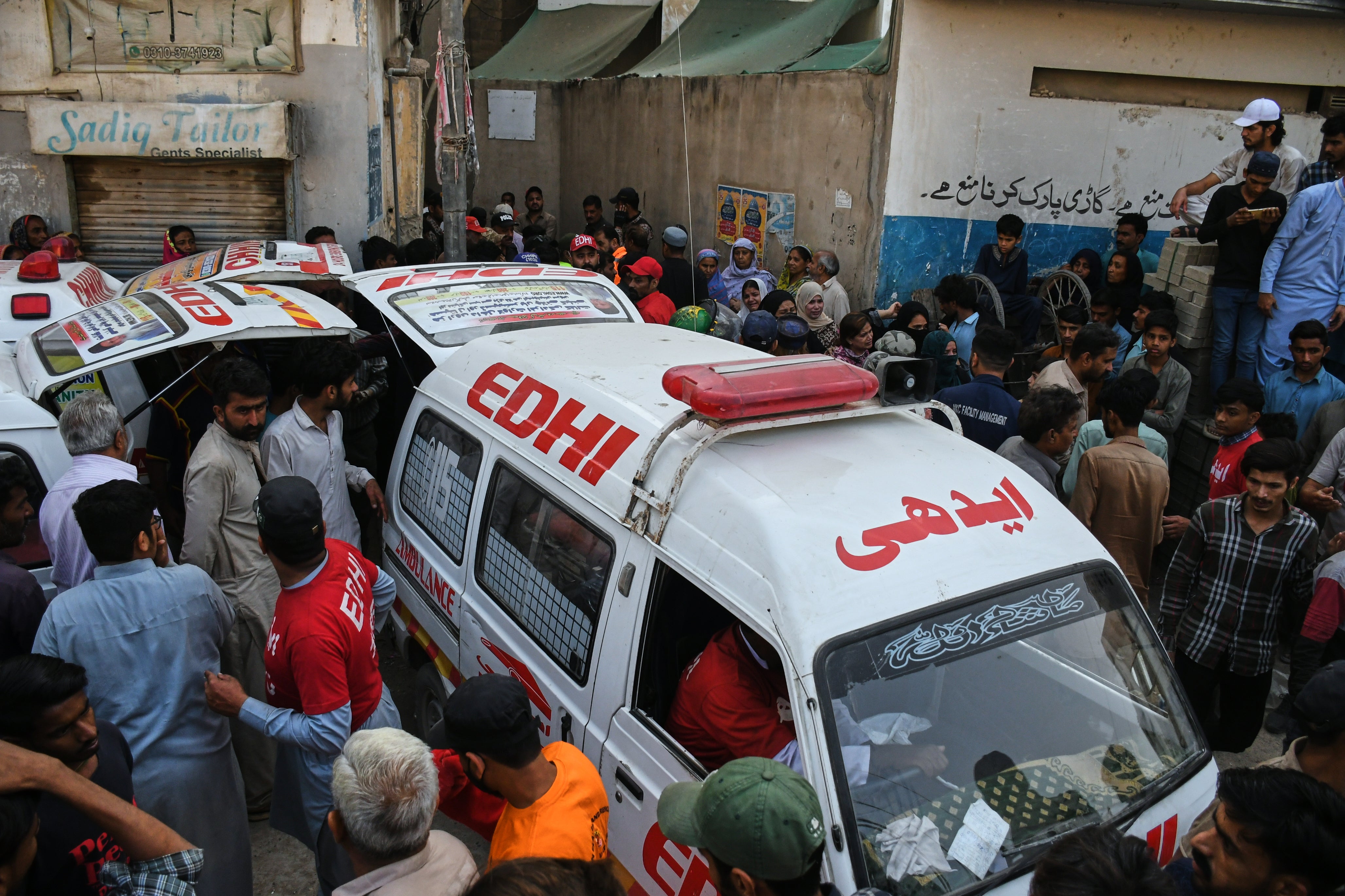 Rescue workers load a body into an ambulance after recovering it from the rubble following a gas explosion at an apartment building, in Karachi, Pakistan, Thursday, Feb. 19, 2026. (AP Photo/Ali Raza)