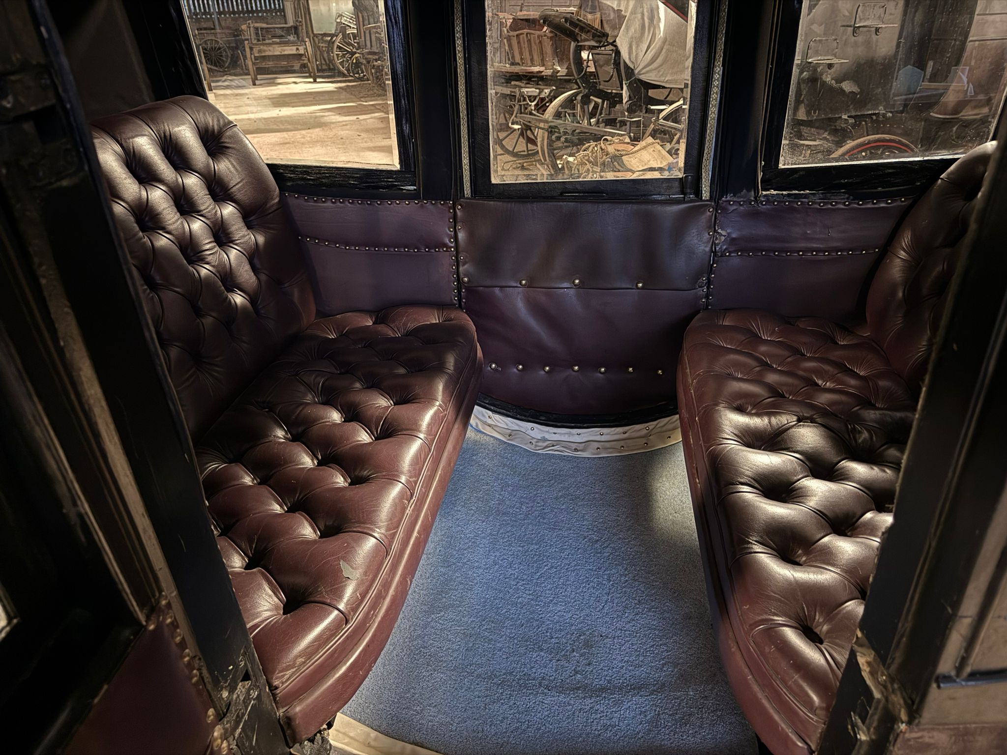 The interior of the carriage features maroon leather seats
