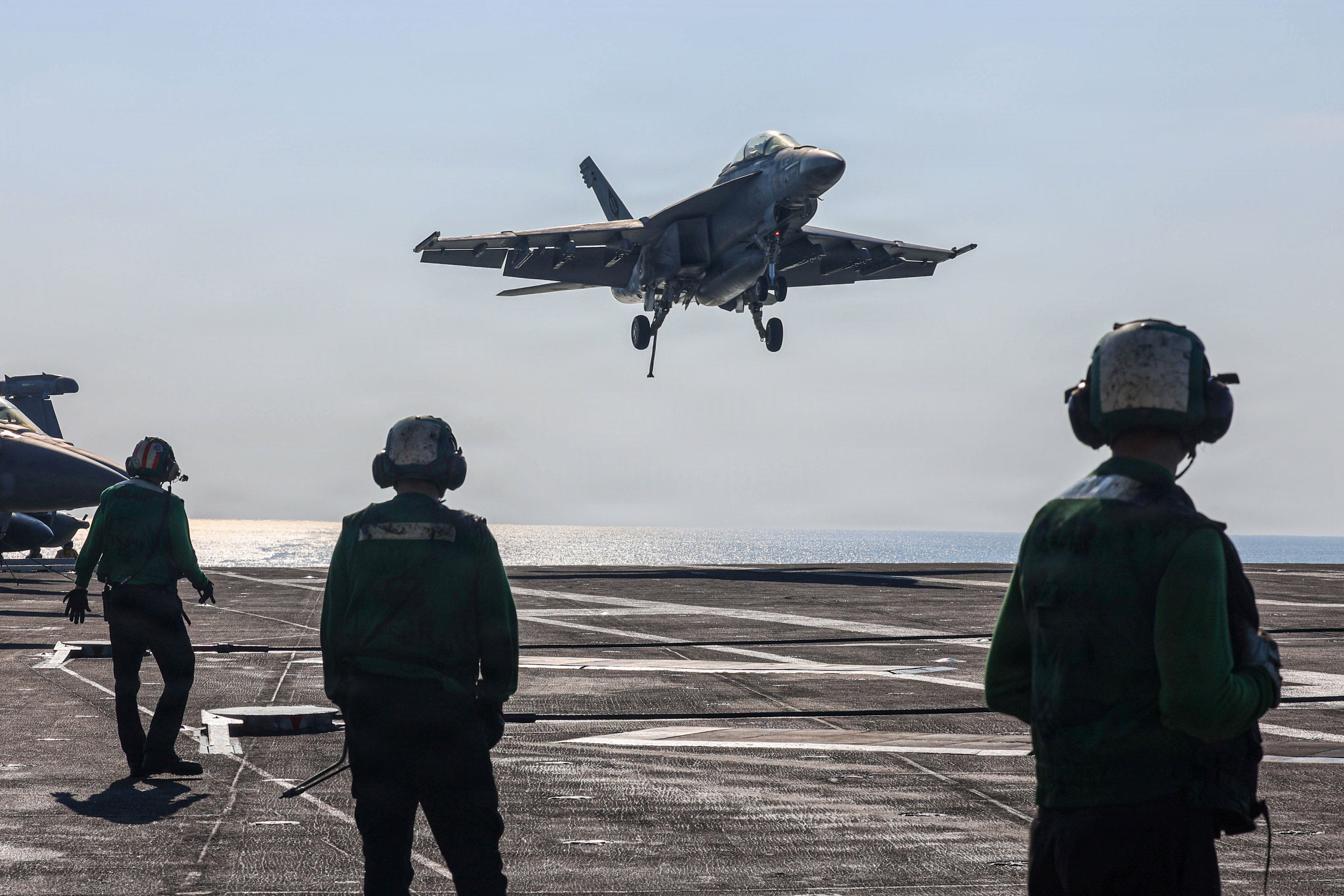 F/A-18 Super Hornets from Strike Fighter Squadron 14 land on the deck of USS Abraham Lincoln in the Arabian Sea