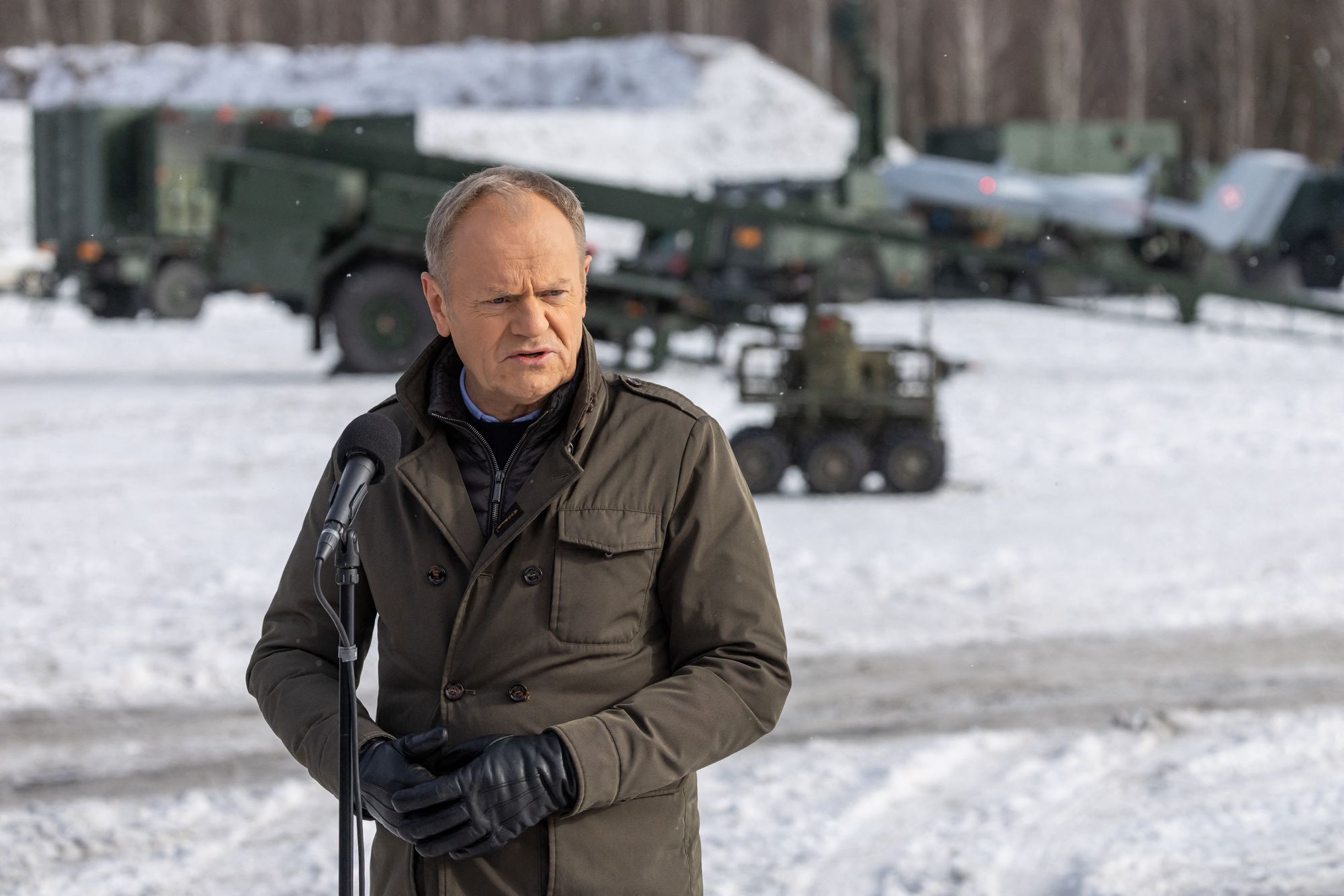 Poland's Prime Minister Donald Tusk speaks to the press after watching an open test of unmanned weapon systems conducted by Polish Armaments Group (Polska Grupa Zbrojeniowa) at the Military Institute of Armament Technology training ground in Zielonka, Warsaw