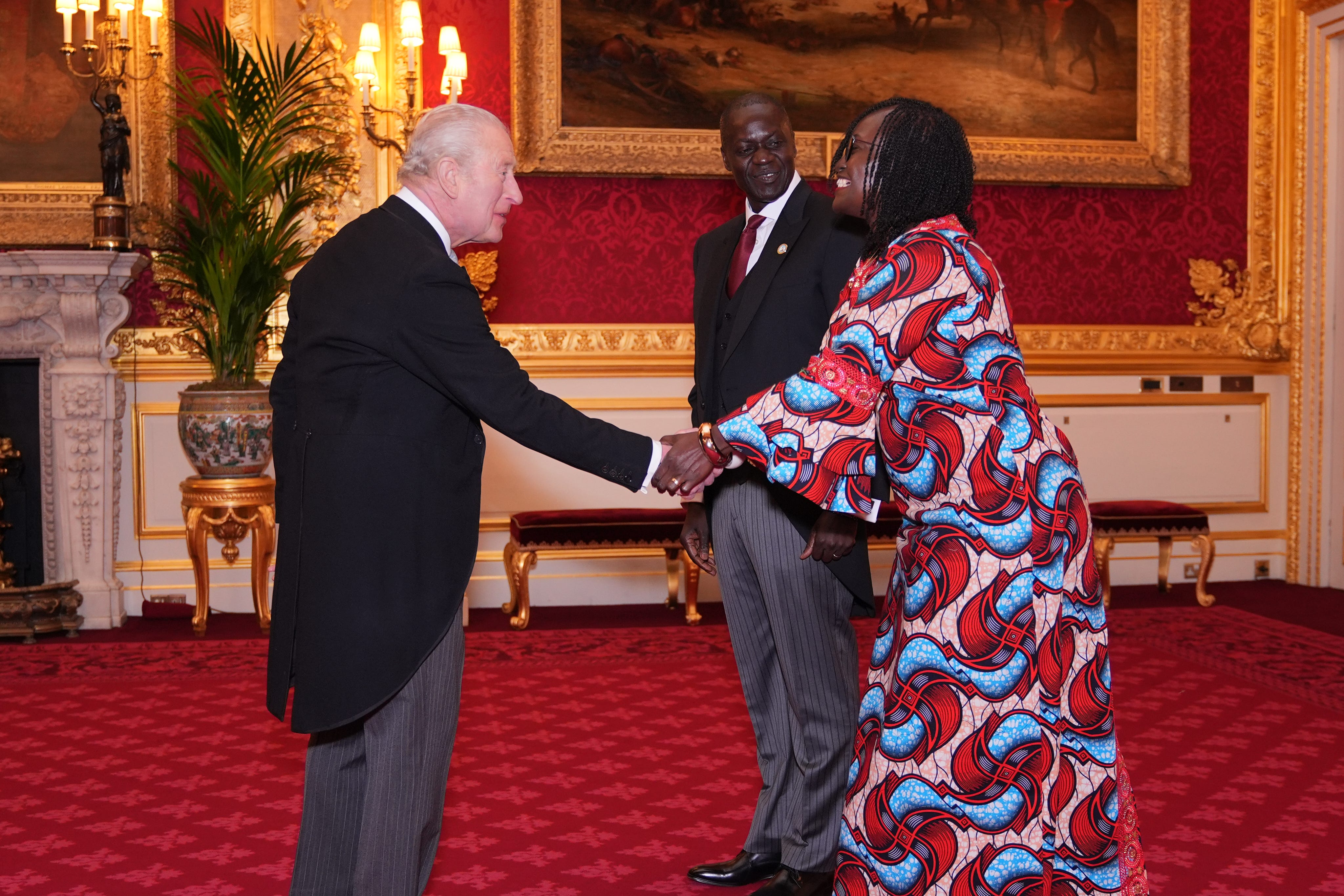 The King welcomes Kenyan high commissioner Maurice Makoloo, accompanied by Christine Asoma, to St James’s Palace (Yui Mok/PA)