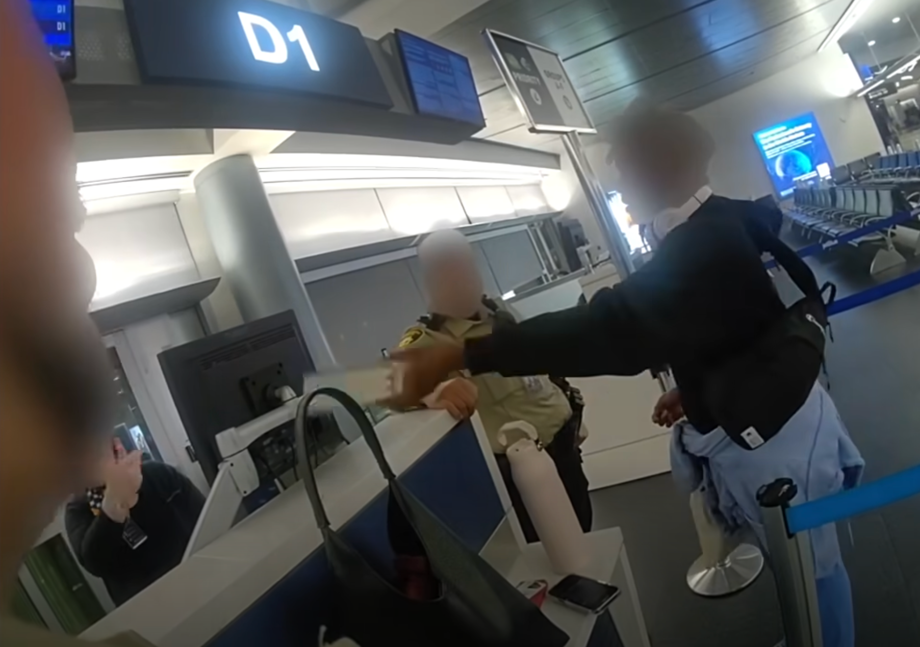 The woman attempts to board her flight as an airport officer confronts her about why she has abandoned her dog.