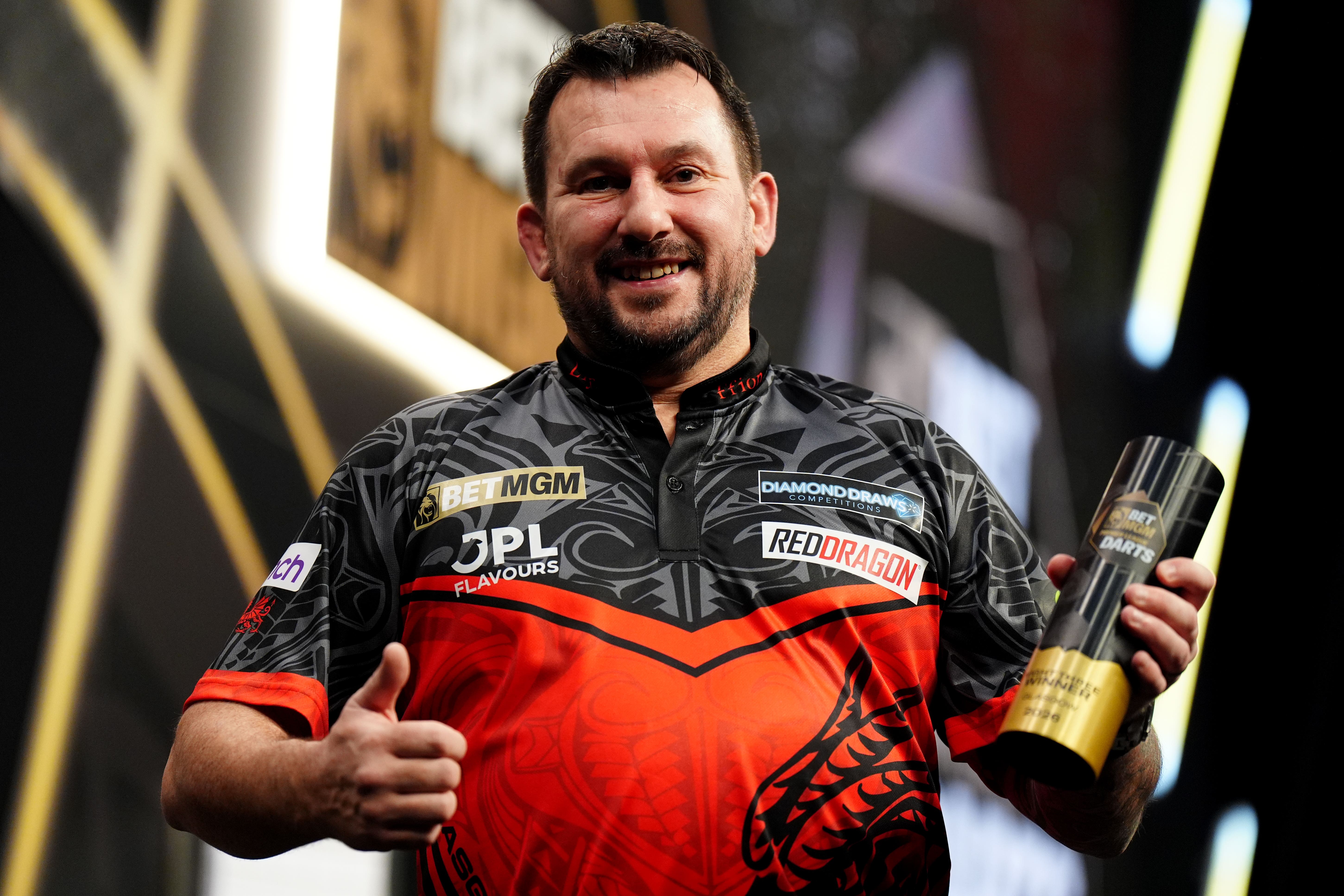 Wales’ Jonny Clayton celebrates after winning the final against Gian van Veen on night three of the BetMGM Premier League (Jane Barlow/PA)