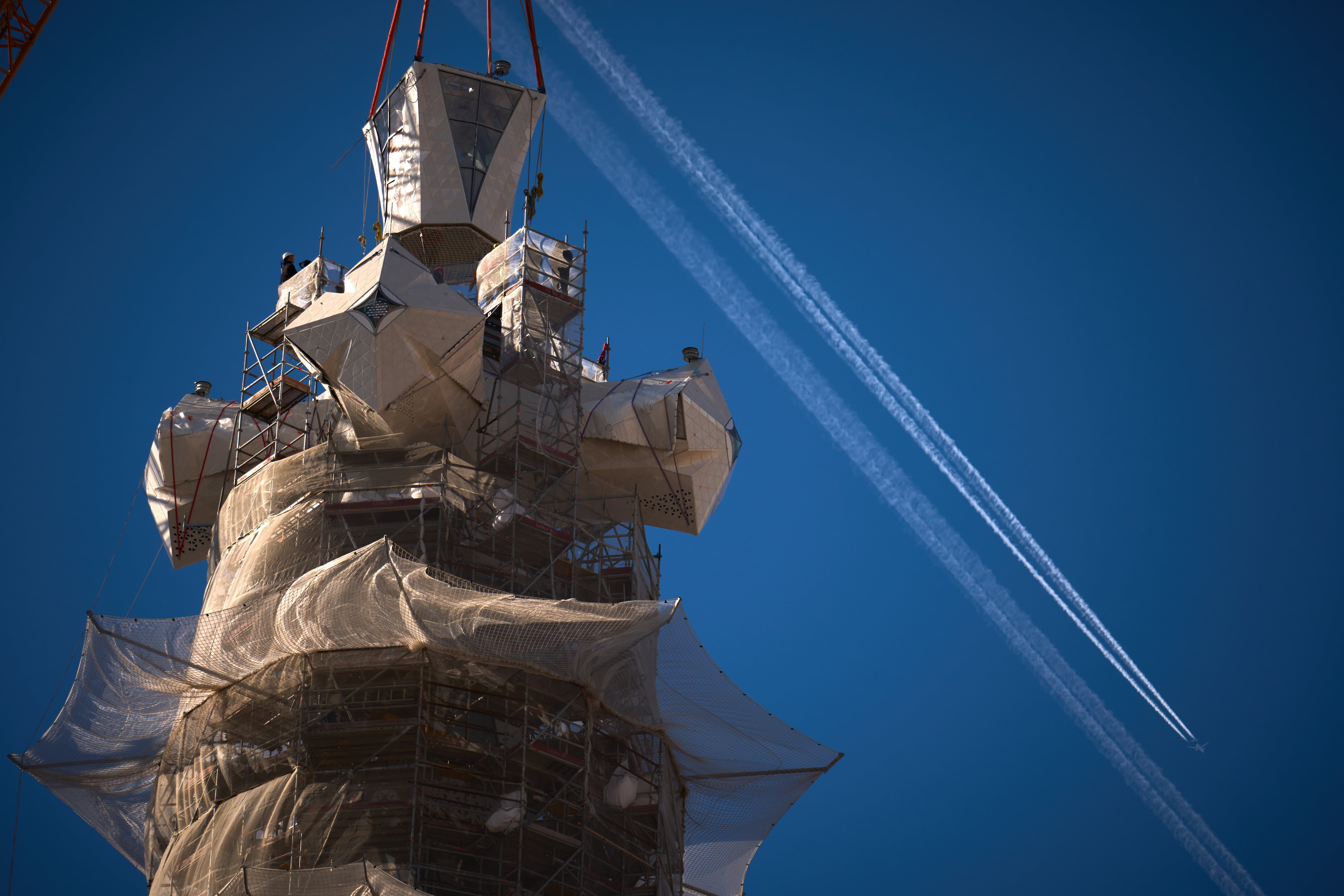 A crane lifts the upper arm of the cross onto the Tower of Jesus Christ at the Sagrada Familia in Barcelona, Spain.