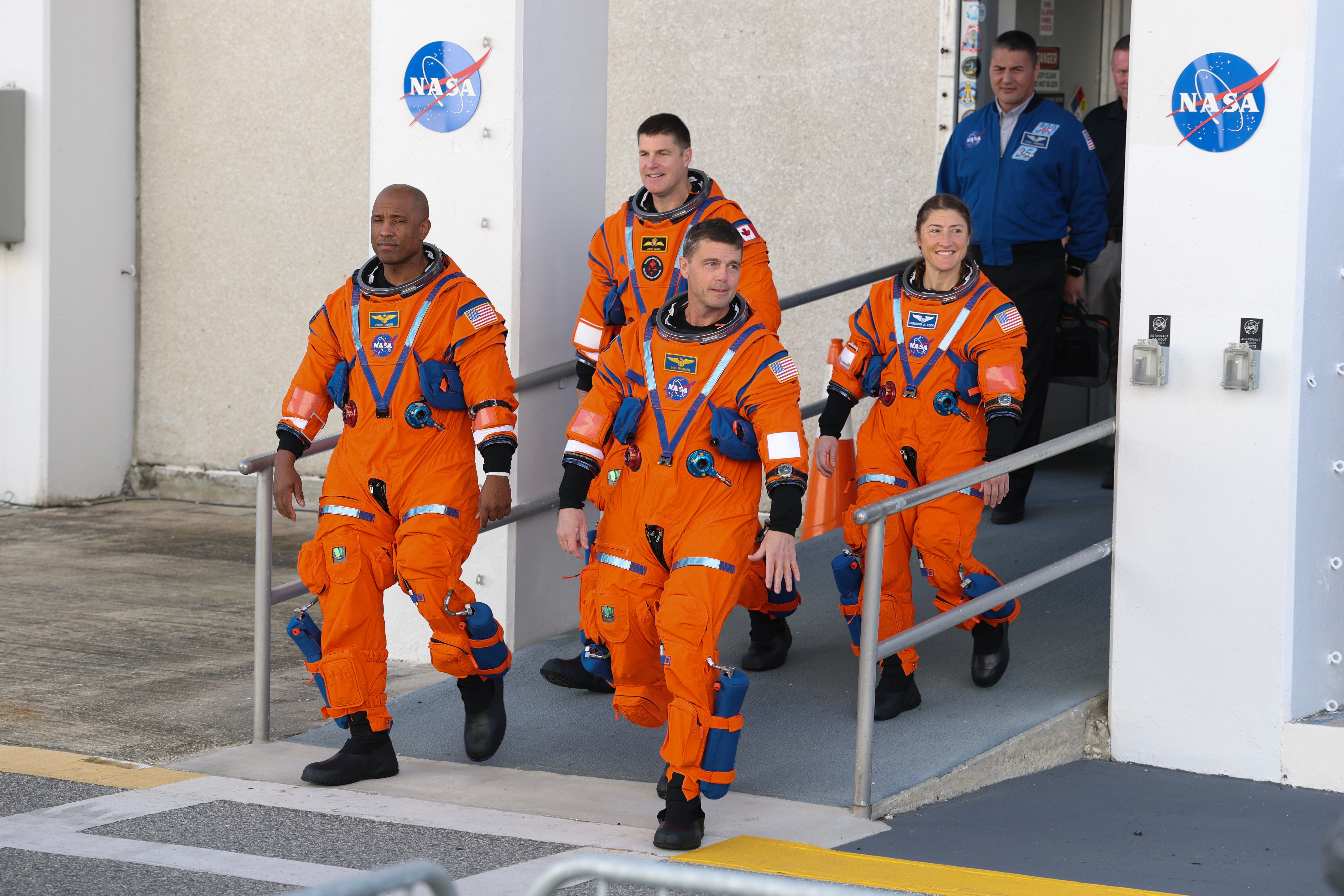 The Artemis II crew – (L-R) pilot Victor Glover, mission specialist Jeremy Hansen of CSA (Canadian Space Agency), commander Reid Wiseman and mission specialist Christina Koch – rehearse a walkout from the Neil A. Armstrong Operations and Checkout Building at NASA’s Kennedy Space Center in Florida on December 20, 2025 in Cape Canaveral, Florida