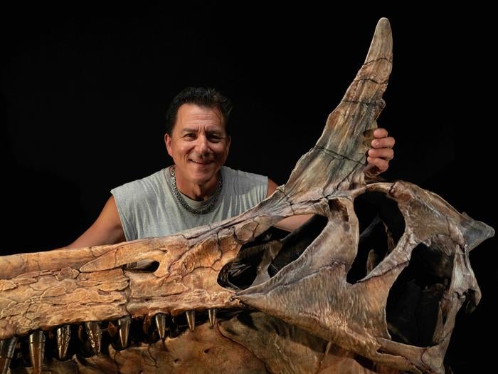 Palaeontologist Paul Sereno with a crest of Spinosaurus mirabilis