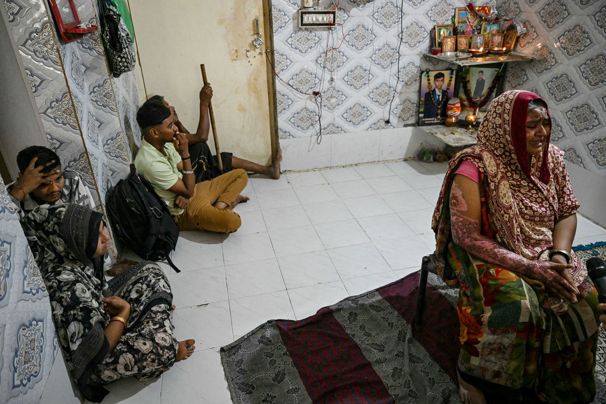 Sita Patni, who suffered burns and lost her son Akash Patni in the Air India crash, mourns alongside relatives at her residence in Ahmedabad