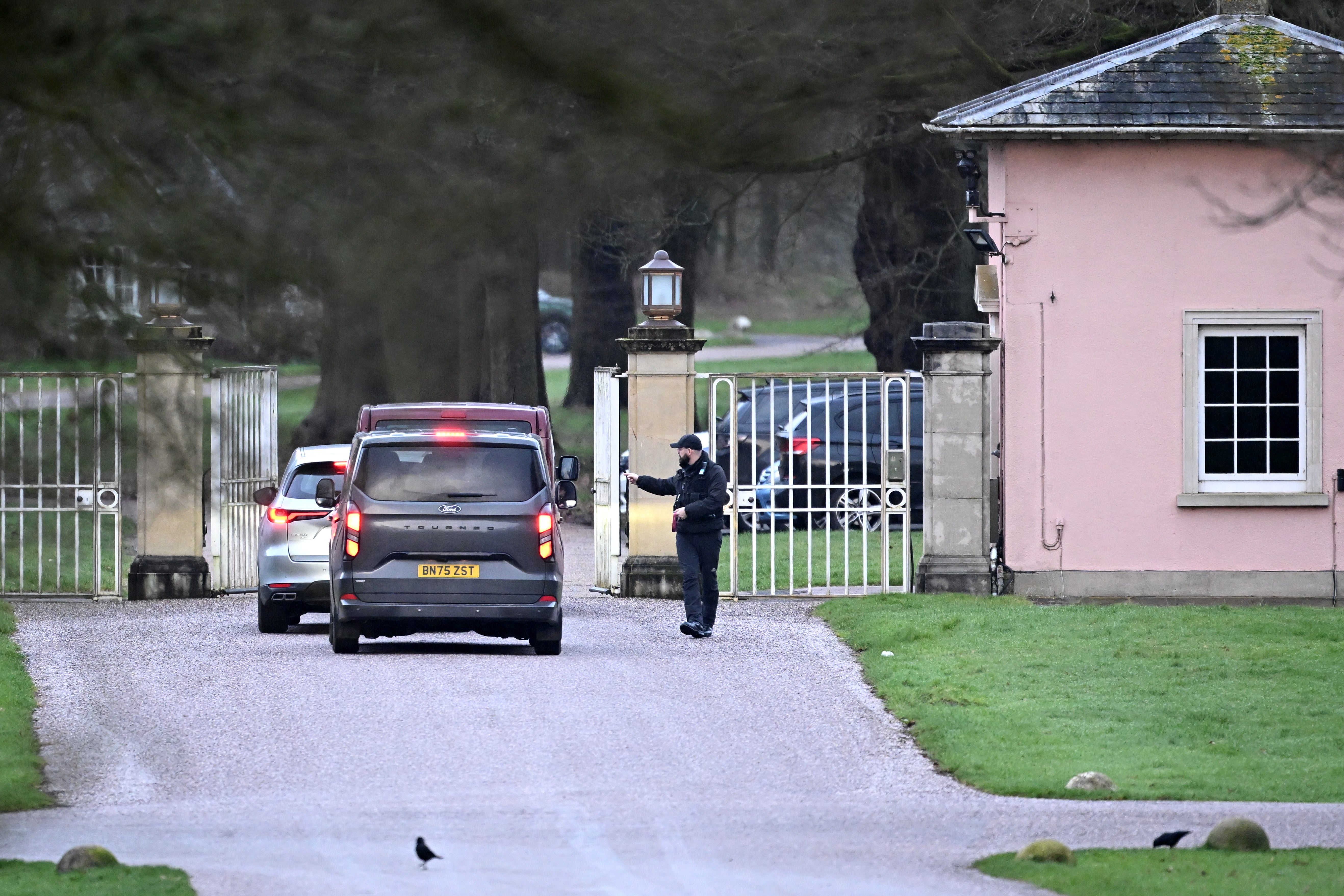 Unmarked vehicles enter the gates of the Royal Lodge, Andrew Mountbatten-Windsor's former residence on 20 February