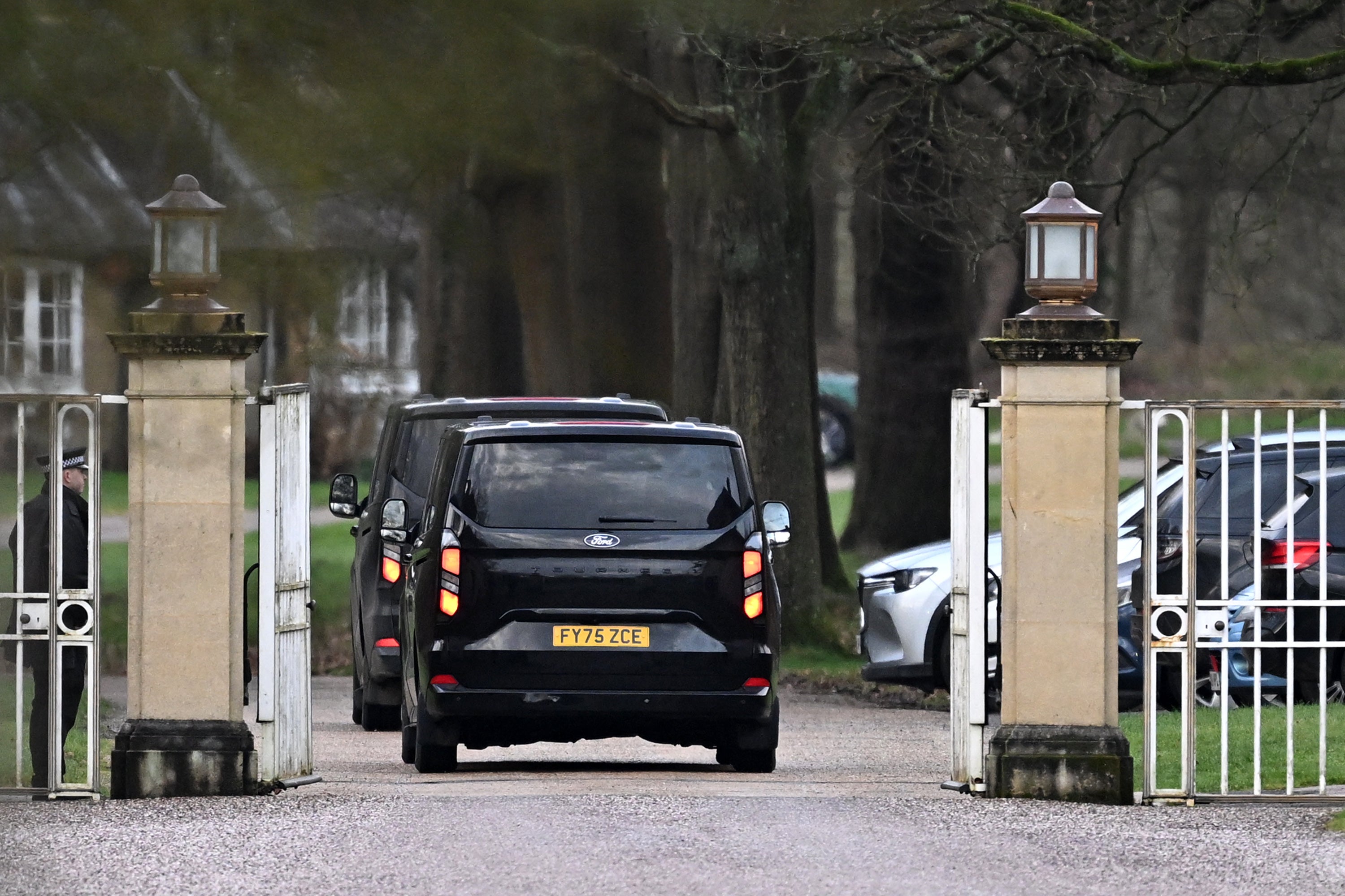 Unmarked vehicles enter the gates of the Royal Lodge, Andrew Mountbatten-Windsor's former residence on 20 February