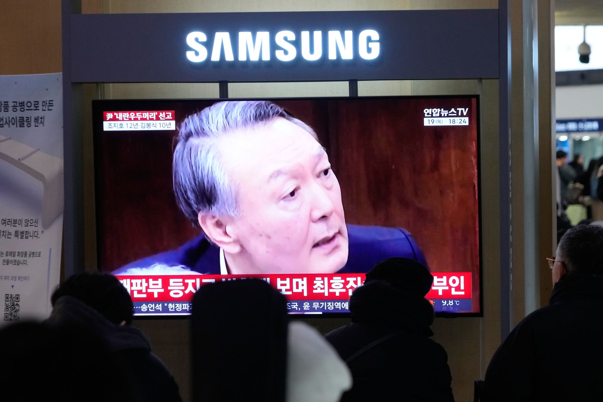 A TV screen shows former South Korean president Yoon Suk Yeol at the Seoul Railway Station on 19 February 2026