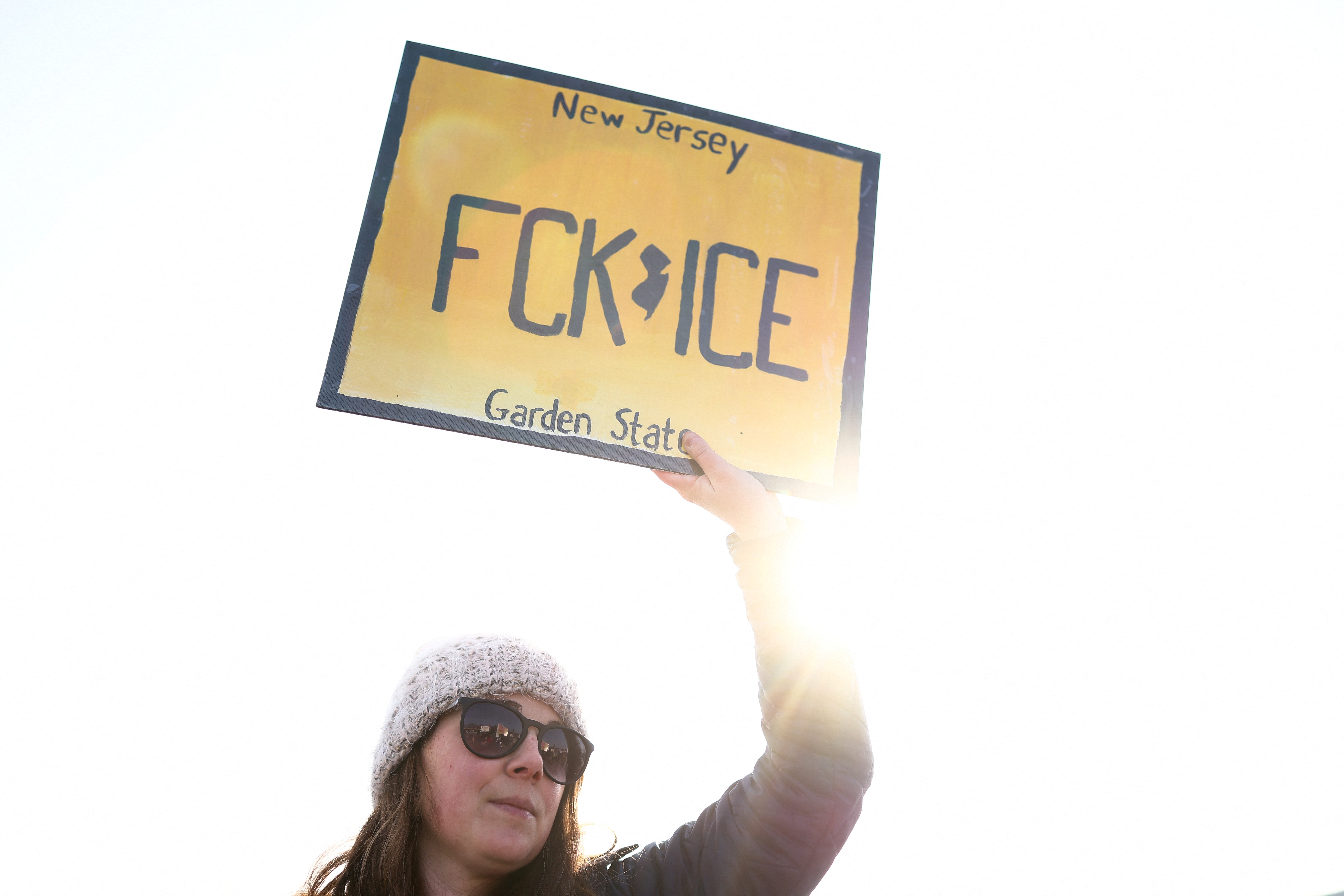 A person holds a sign during a February 2026 protest in Roxbury, New Jersey, as local legislators introduce new legislation known as the F**K ICE Act”