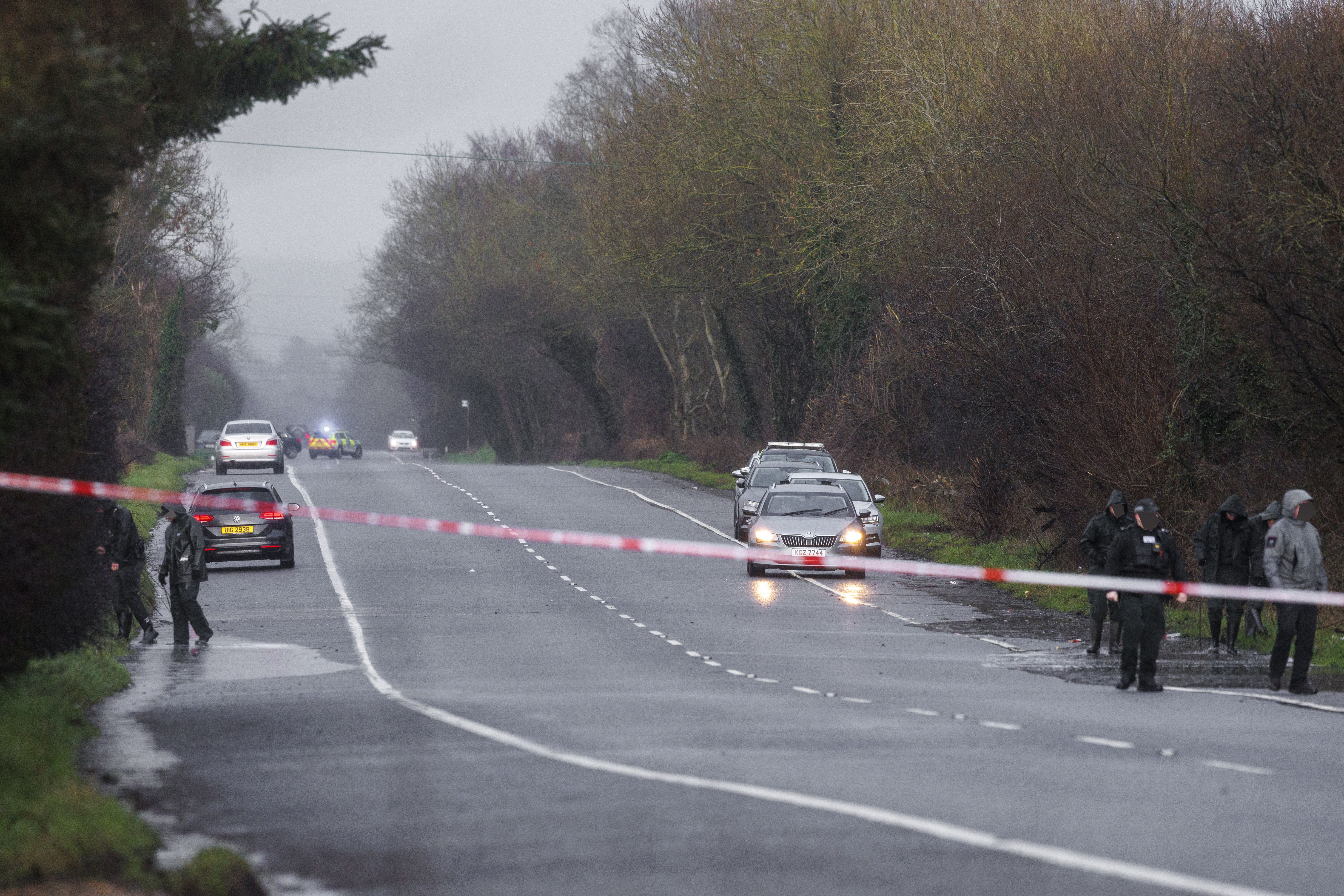 PSNI officers searching at the scene near Moy in County Tyrone after three people died and four people were injured following a serious crash on the Armagh Road (Liam McBurney/PA)