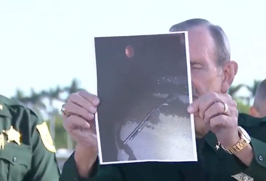 Palm Beach County Sheriff Ric Bradshaw held up a grainy photo of the suspect, who was carrying a shotgun when law enforcement officers swooped