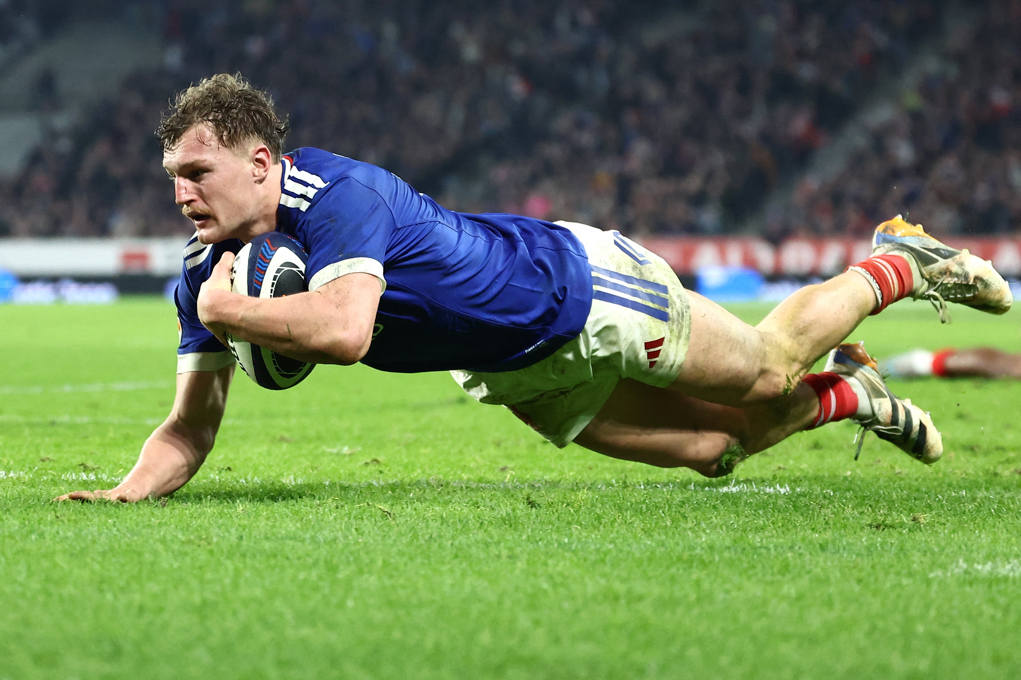 France's centre Emilien Gailleton dives across the line to score their fifth try
