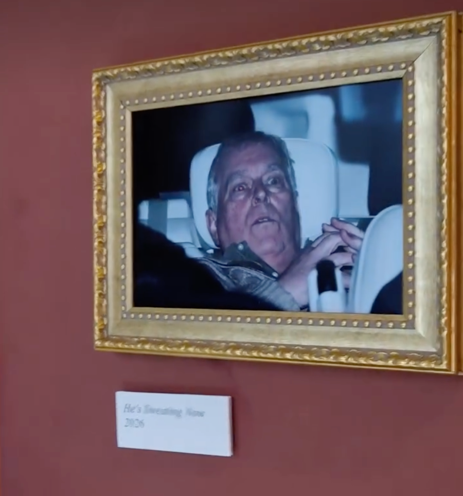 Protesters hang photo of Andrew leaving police station in the Louvre