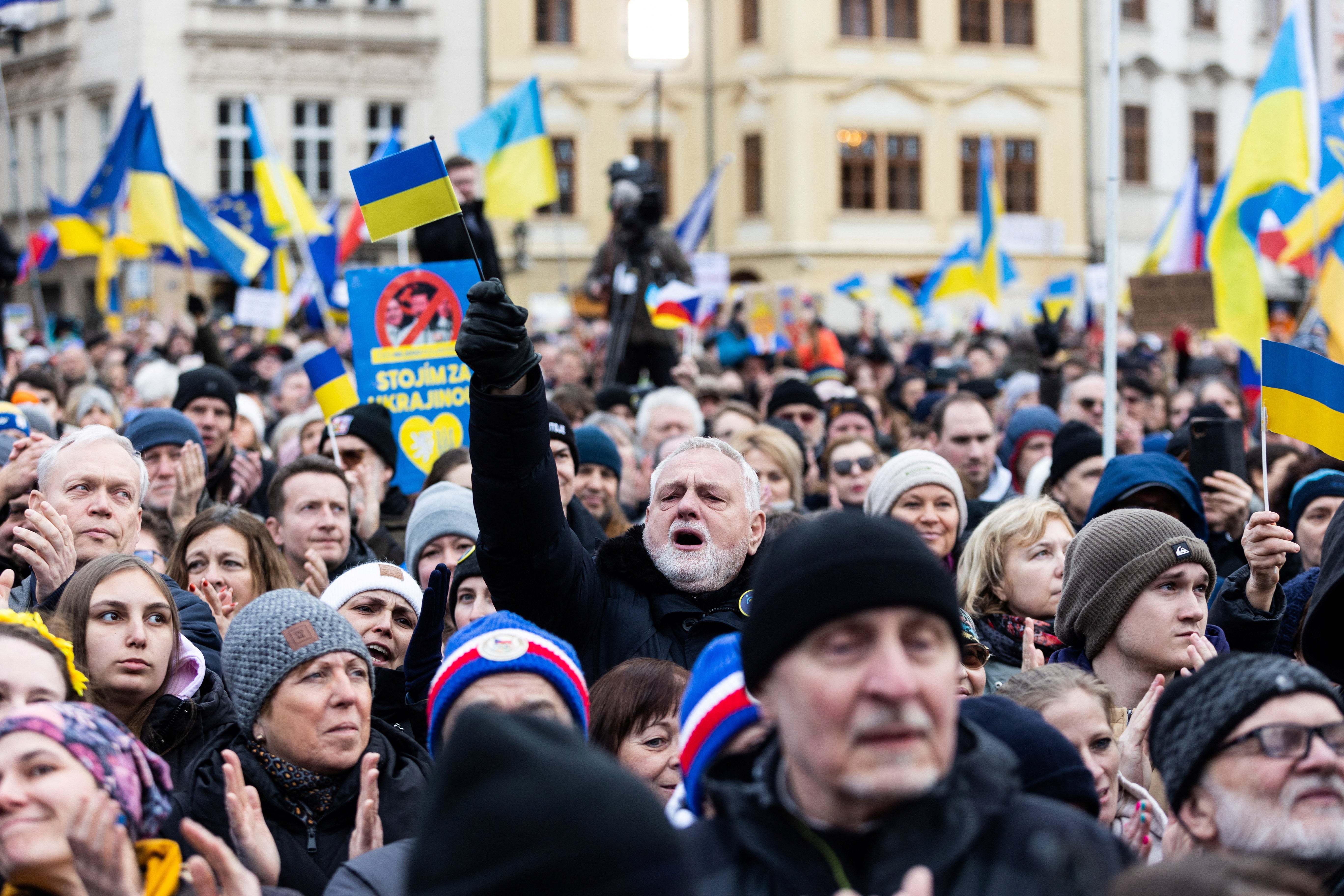 People attend a protest to mark the four-year anniversary of the Russian invasion of Ukraine, at the Old Town Square, in Prague, Czech Republic
