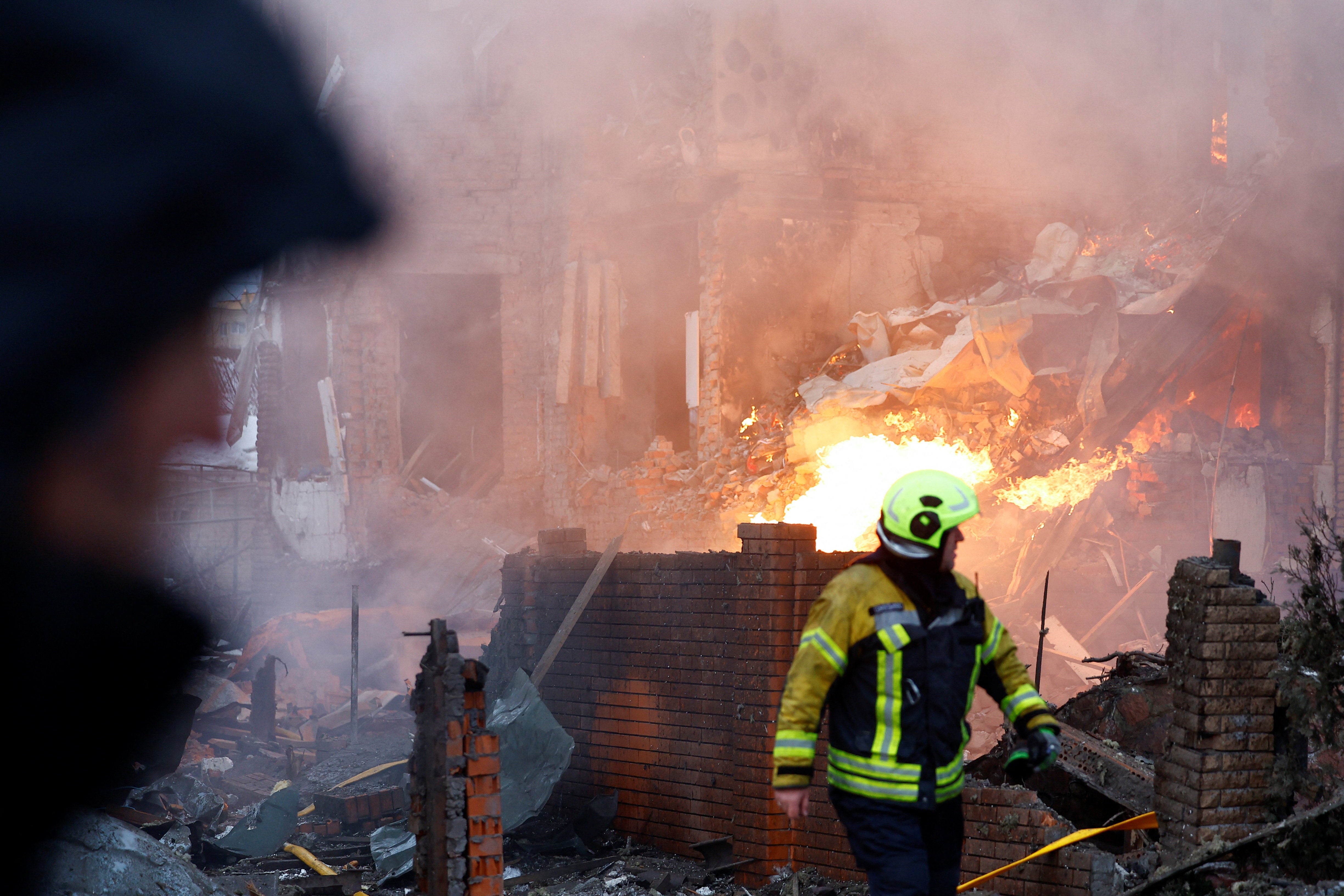 <p>A firefighter works at the site of a residential building damaged during Russian drone and missile strikes</p>
