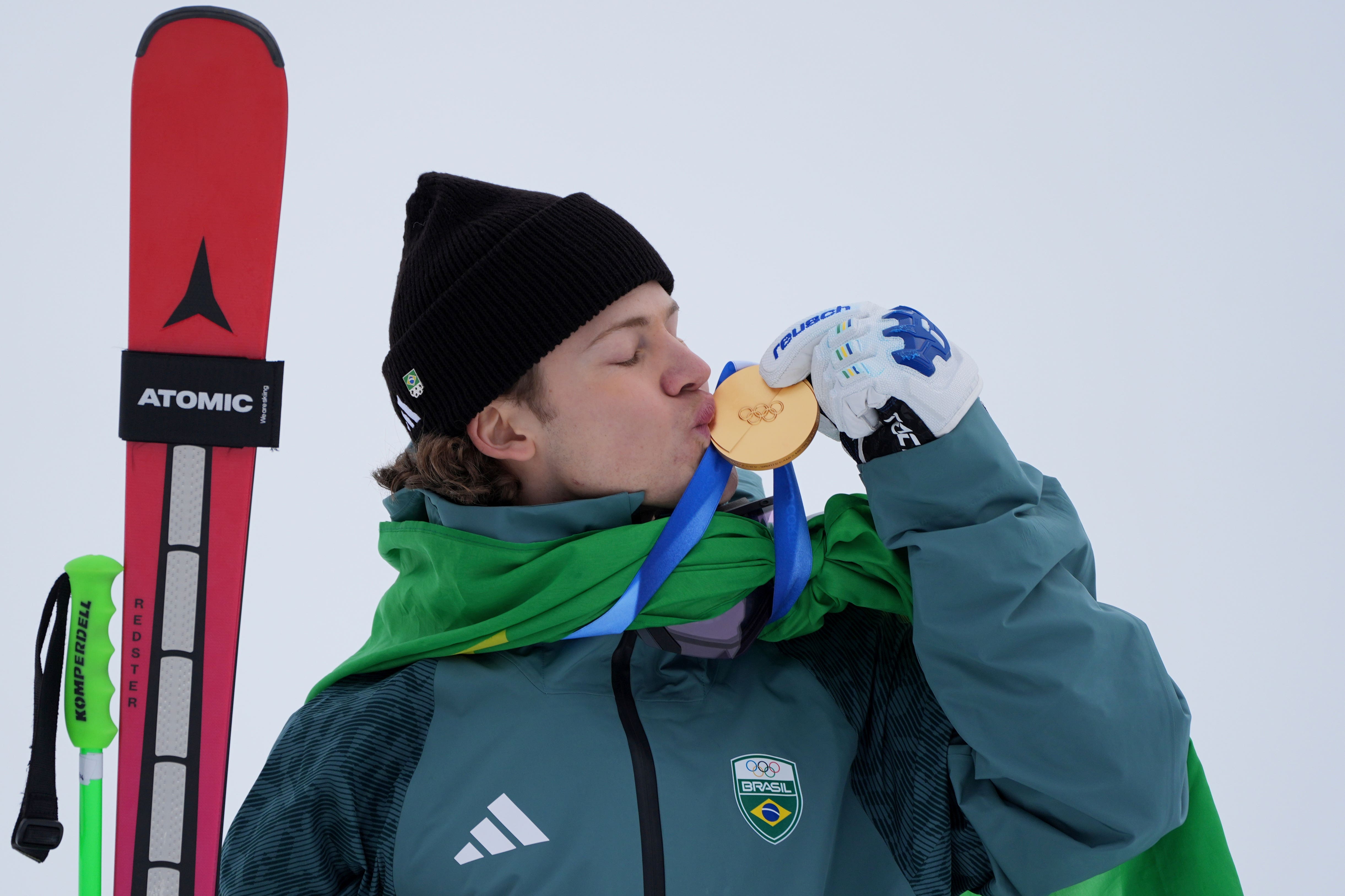 Brazil’s Lucas Pinheiro Braathen kisses his gold medal (Rebecca Blackwell/AP)
