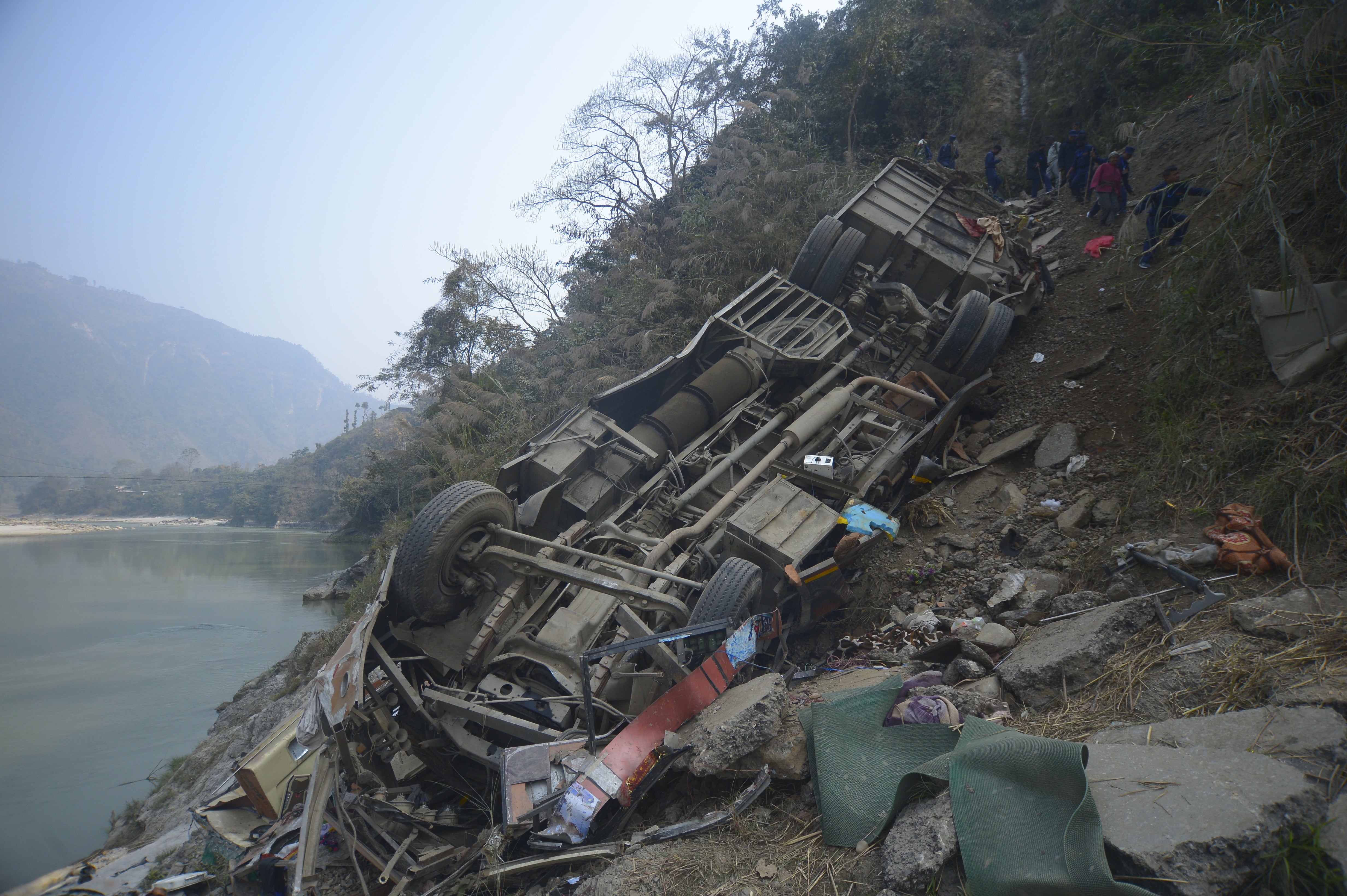 The passenger bus drove off a mountain highway near Benighat, west of the capital Kathmandu