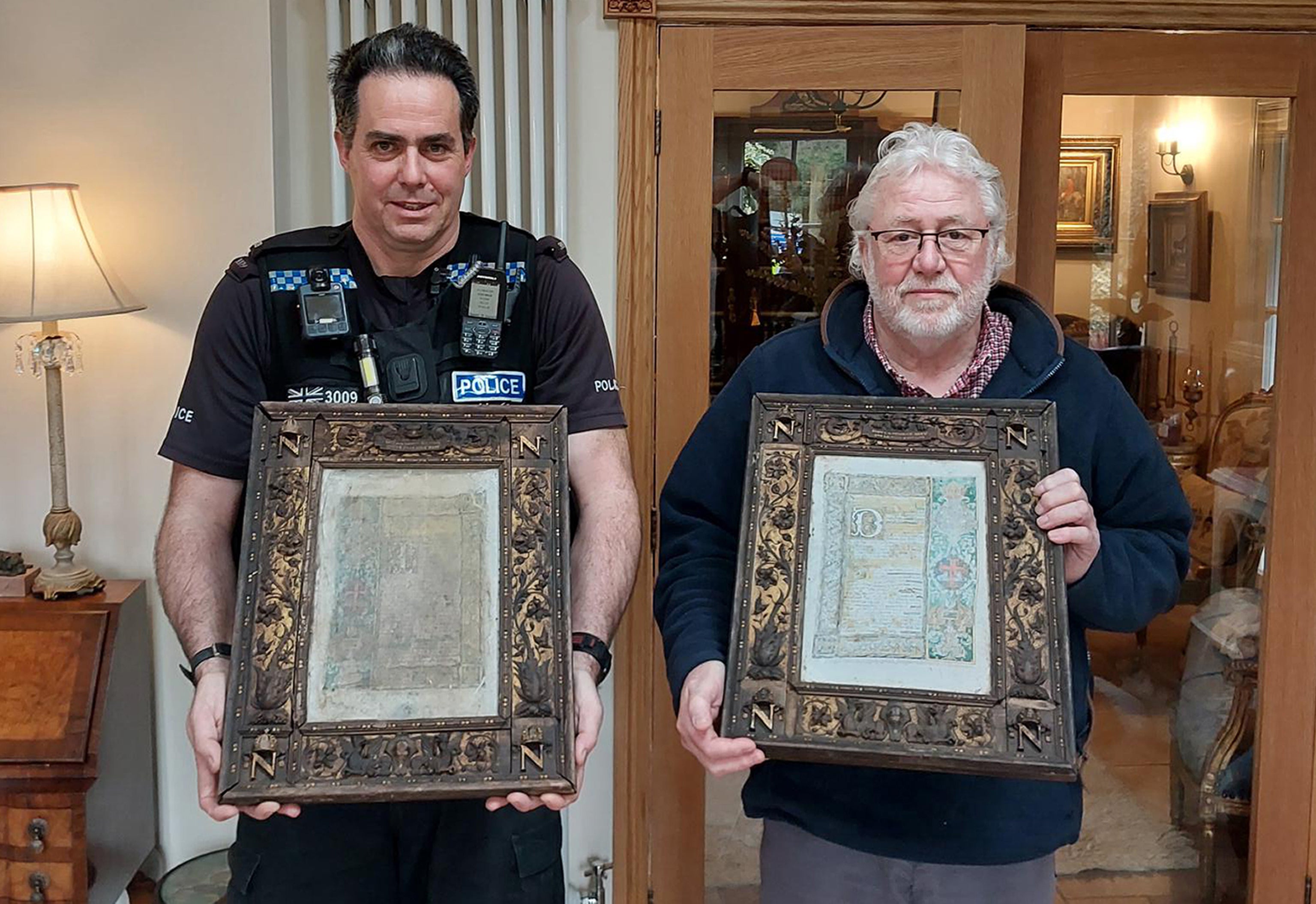 PC Mark Webb and Paul Gostelow with two of three 'priceless' altar plaques stolen from the crypt of Napoleon Bonaparte III in a Hampshire monastery