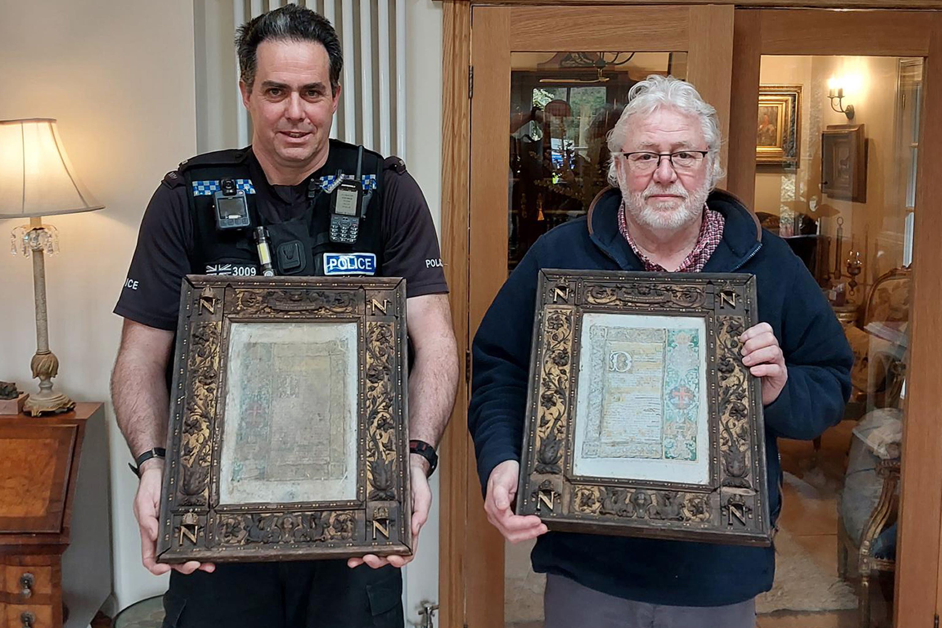 Pc Mark Webb and Paul Gostelow with two of three ‘priceless’ altar plaques stolen from the crypt of Napoleon Bonaparte III in a Hampshire monastery (Hampshire Constabulary/PA)