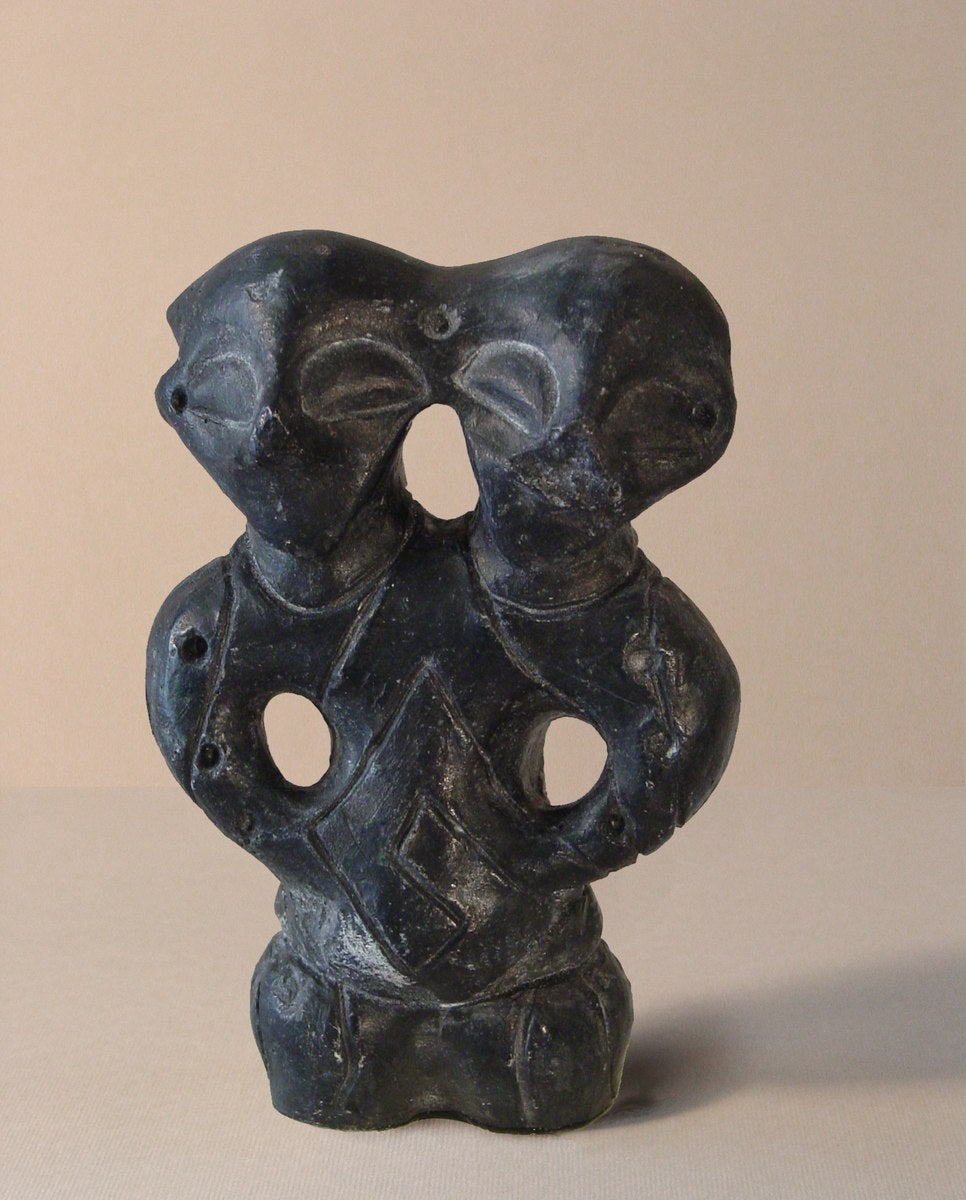 The mass grave was dug inside an Iron Age village in around 850 BC - but the settlement was already thousands of years old. This little double-headed sculpture is from one of its earliest phases - around 5000 BC