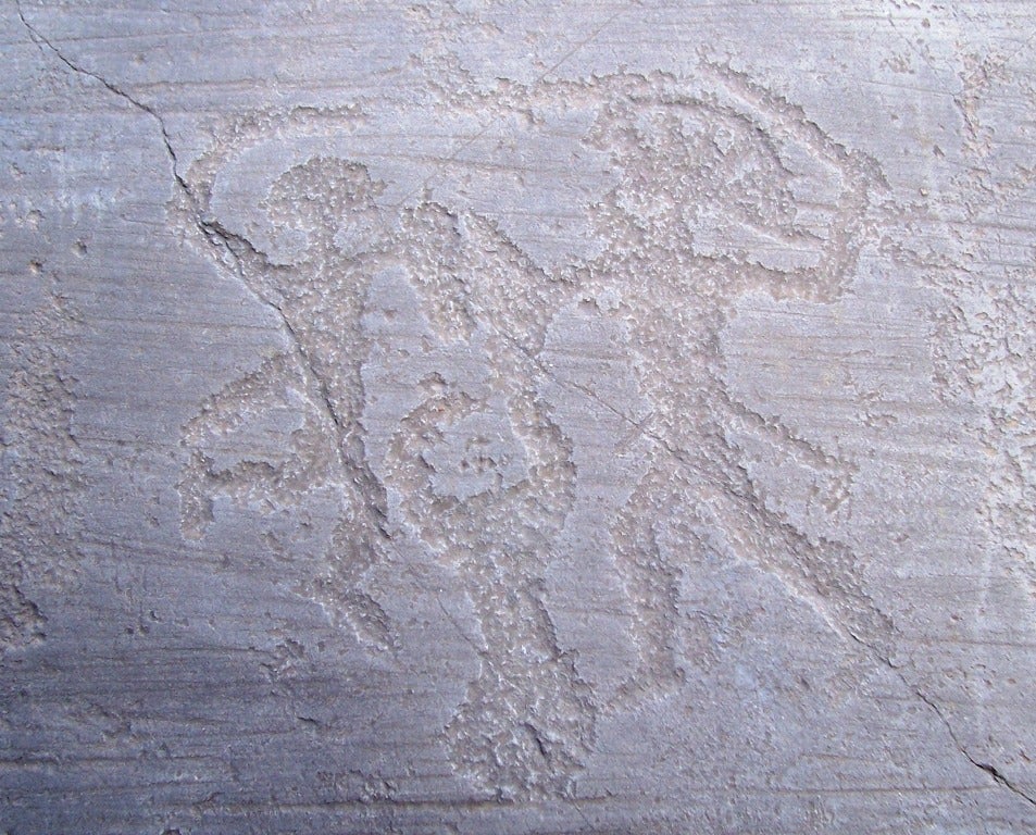  In this prehistoric rock art engraving from northern Italy, dating from around the time of the mass grave, two Iron Age warriors, armed with swords and shields, engage in combat