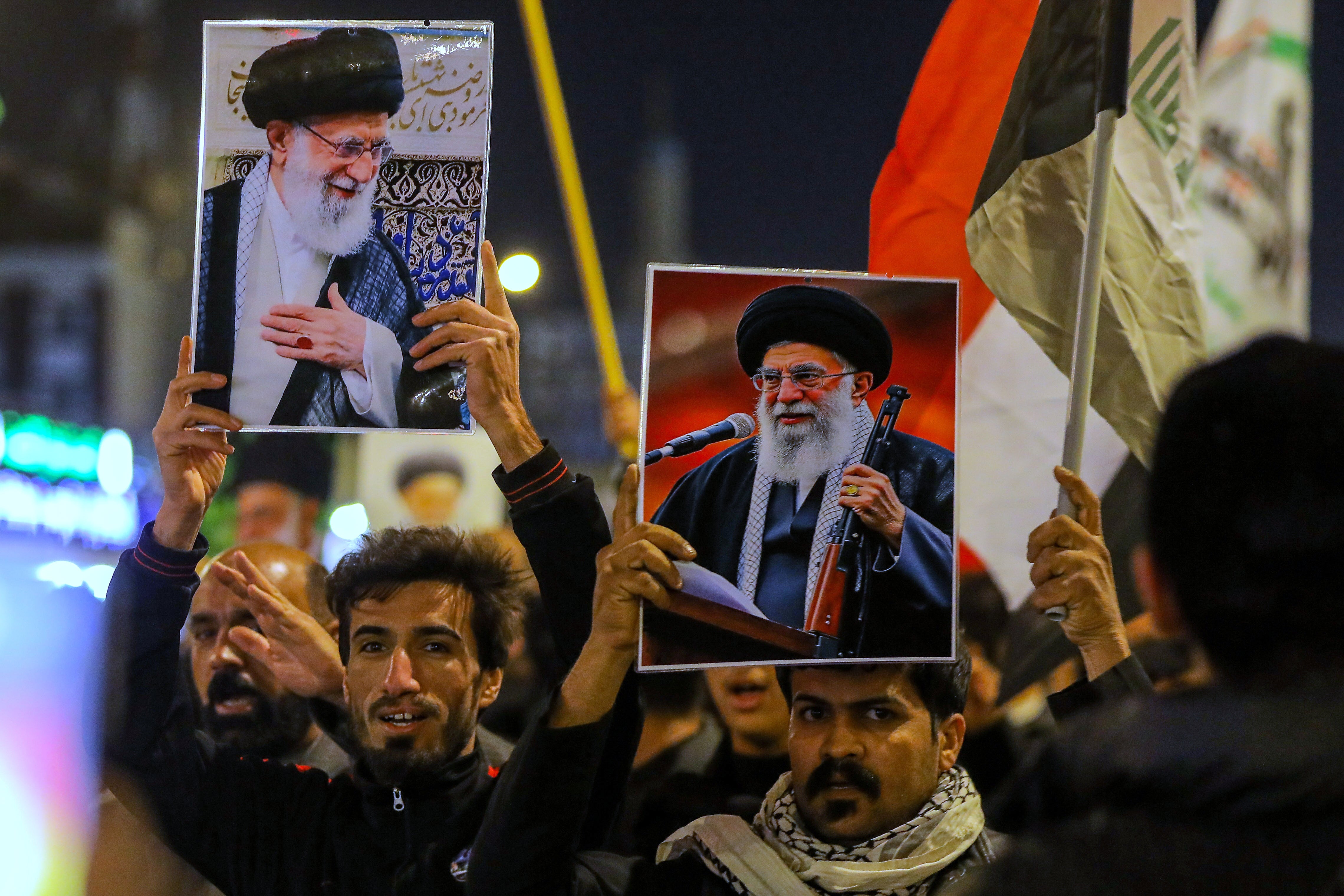 Iraqi Shiites clasp pictures of Khamenei during a symbolic ceremonial successful Najaf, Iraq