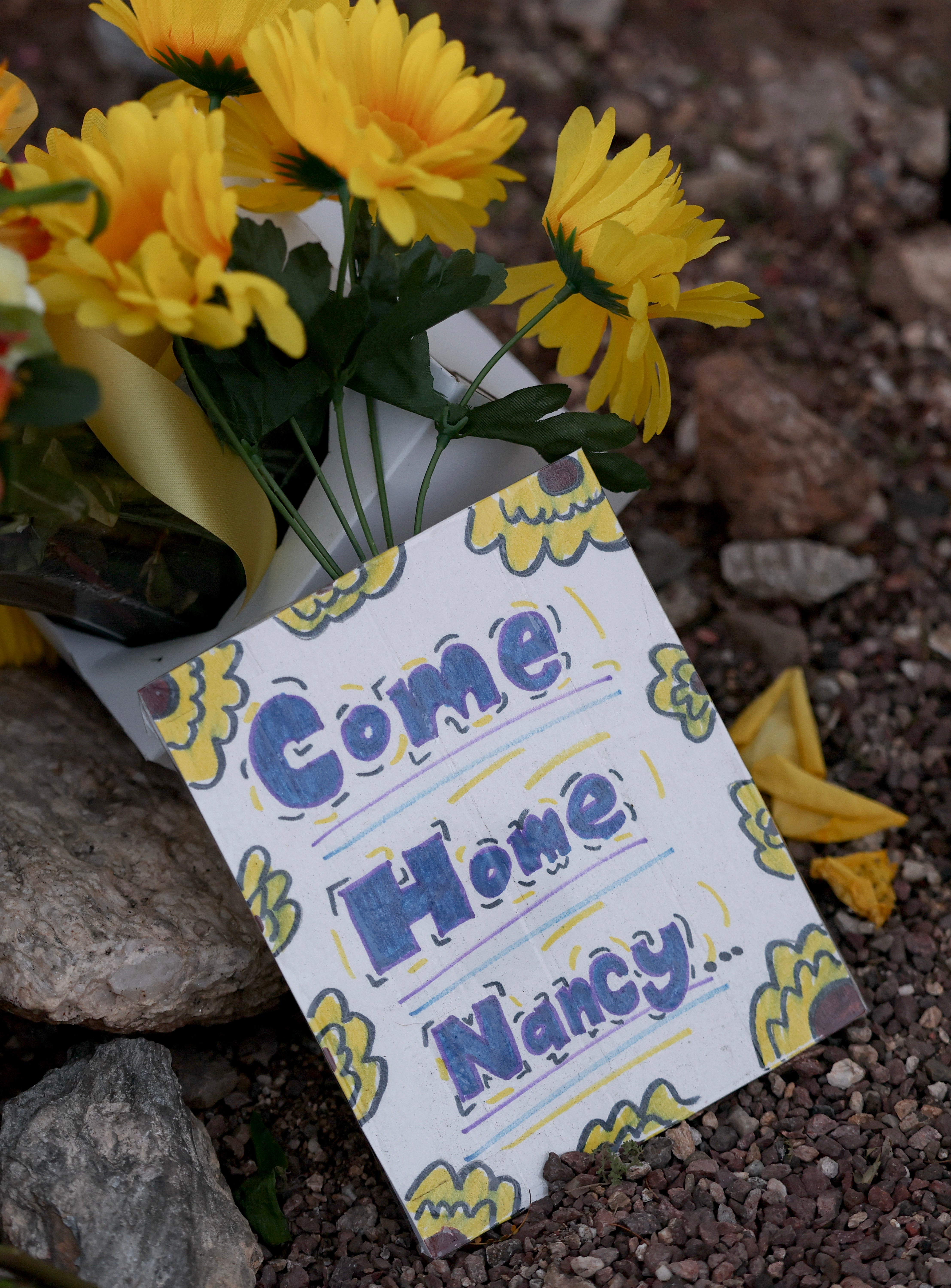 Flowers are piled up outside Nancy Guthrie’s home