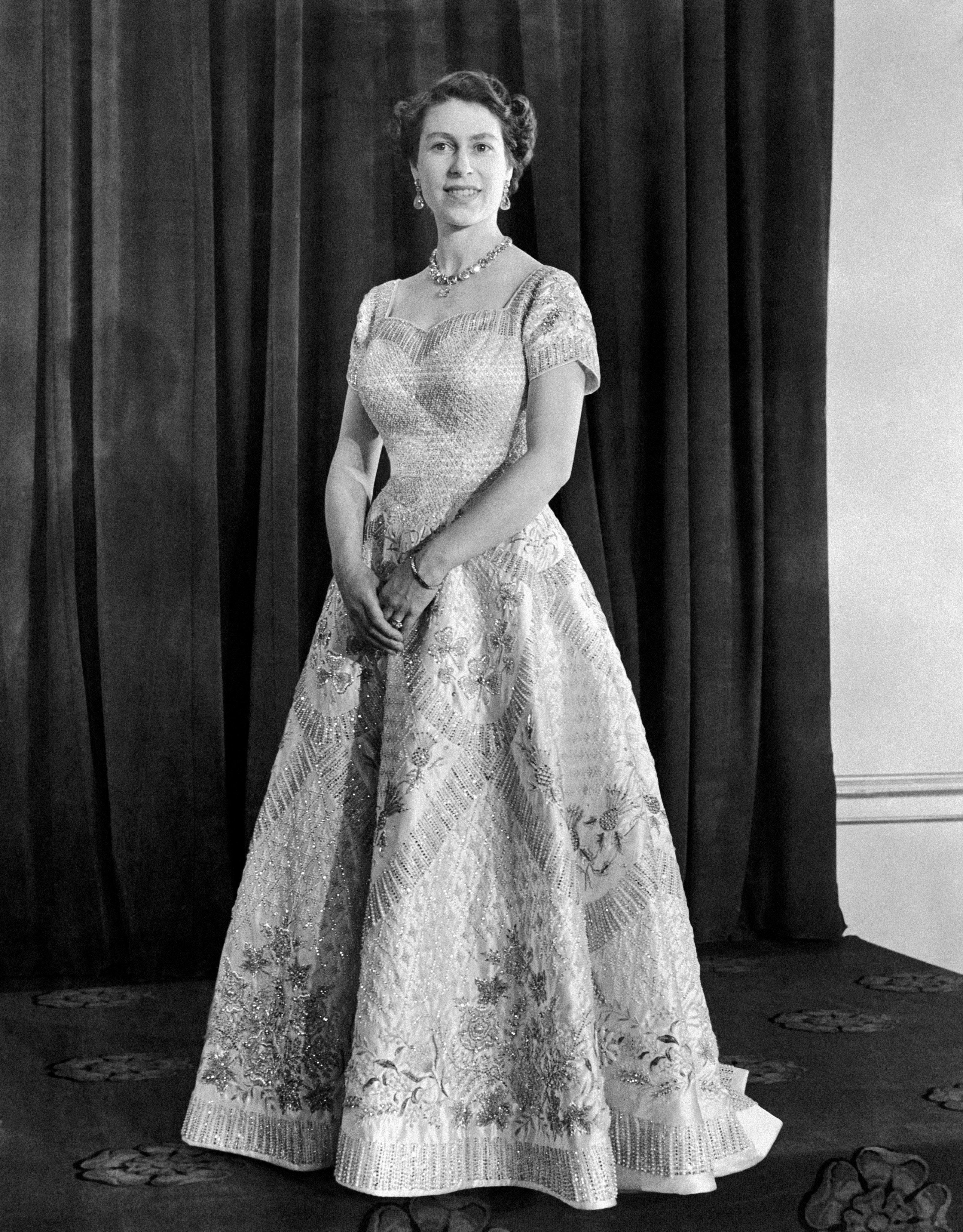 Queen Elizabeth II in 1953 wearing a gown designed by Norman Hartnell for her Coronation (PA Archive/PA)