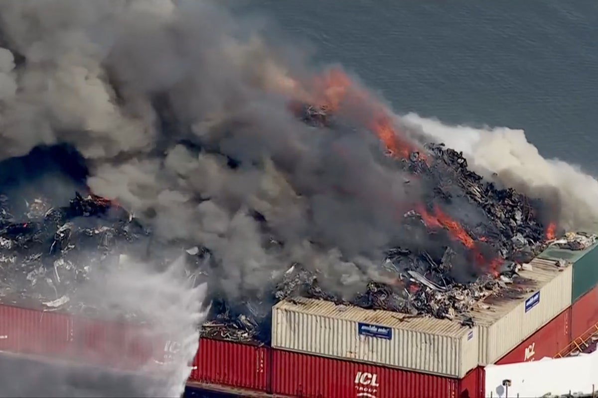 Massive fire erupts on scrap metal barge with smoke billows seen for miles