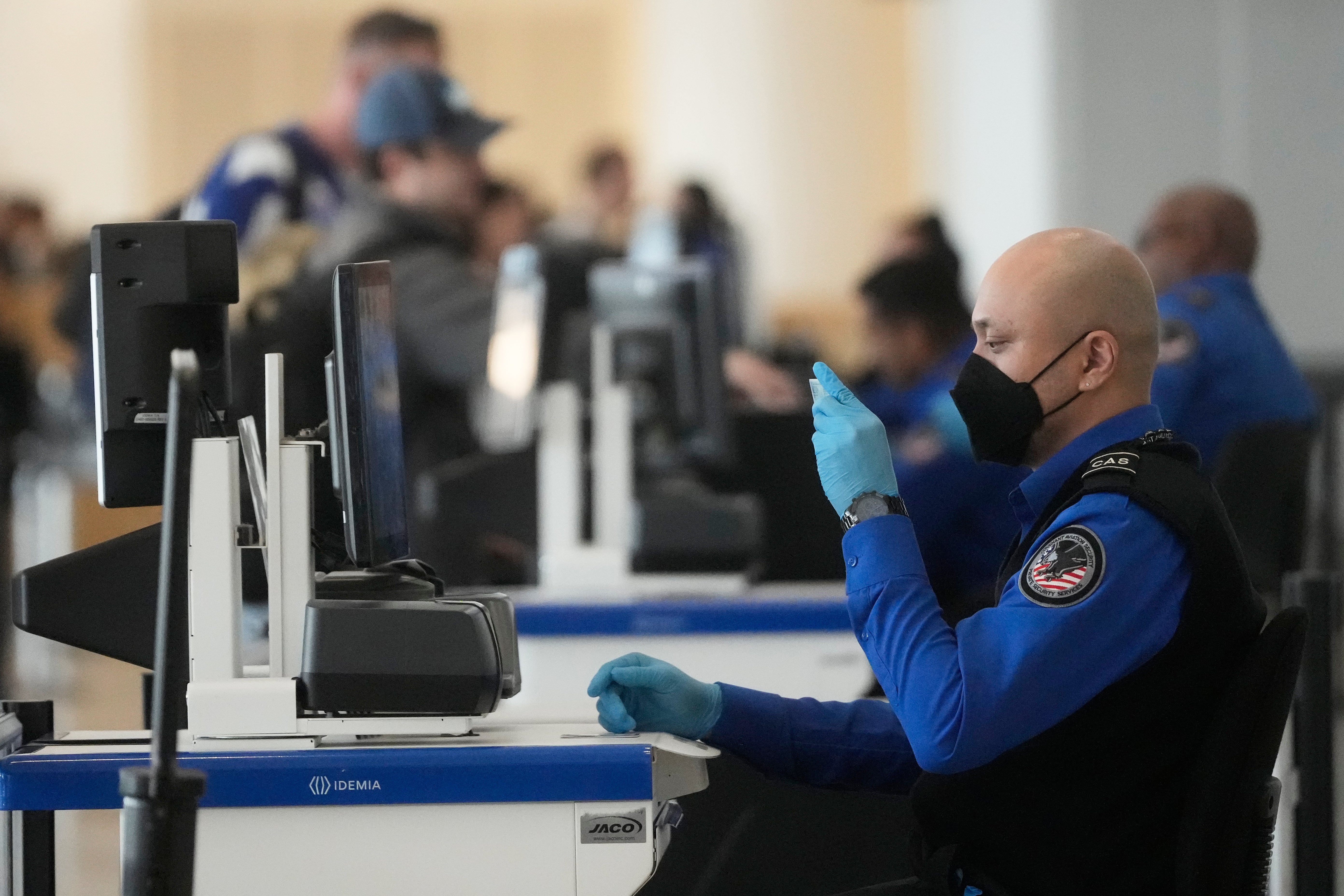 A Covenant Aviation Security Private Security Services supplier checks nan identifcation of a rider astatine a information gross astatine San Francisco International Airport.