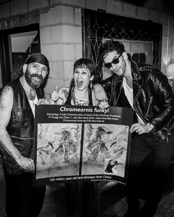 Chromeo member P-Thugg, paleontologist Jingmai O’Connor, and Chromeo member Dave 1, posing with a picture of Chromeornis funkyi